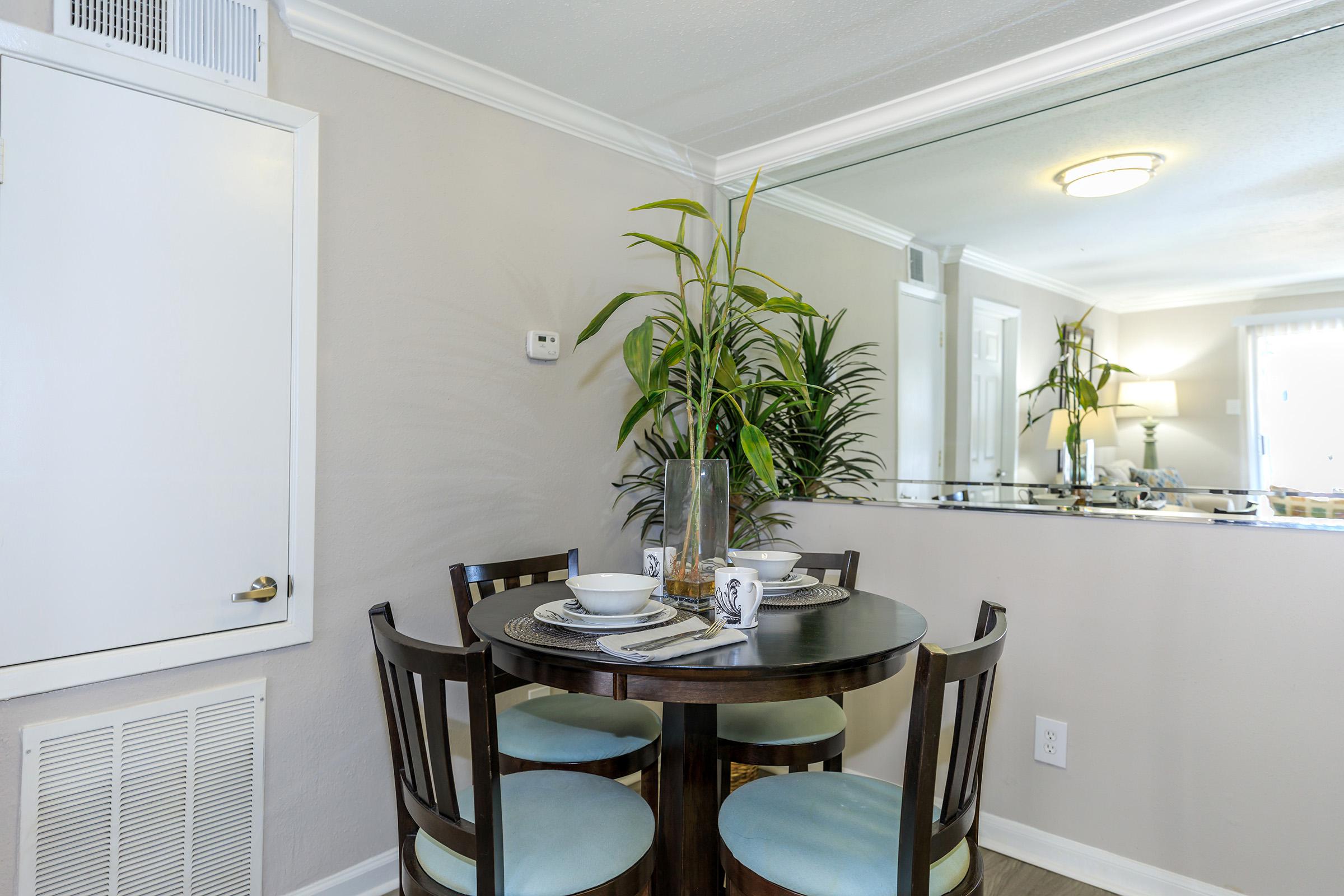 a dining room table in front of a window