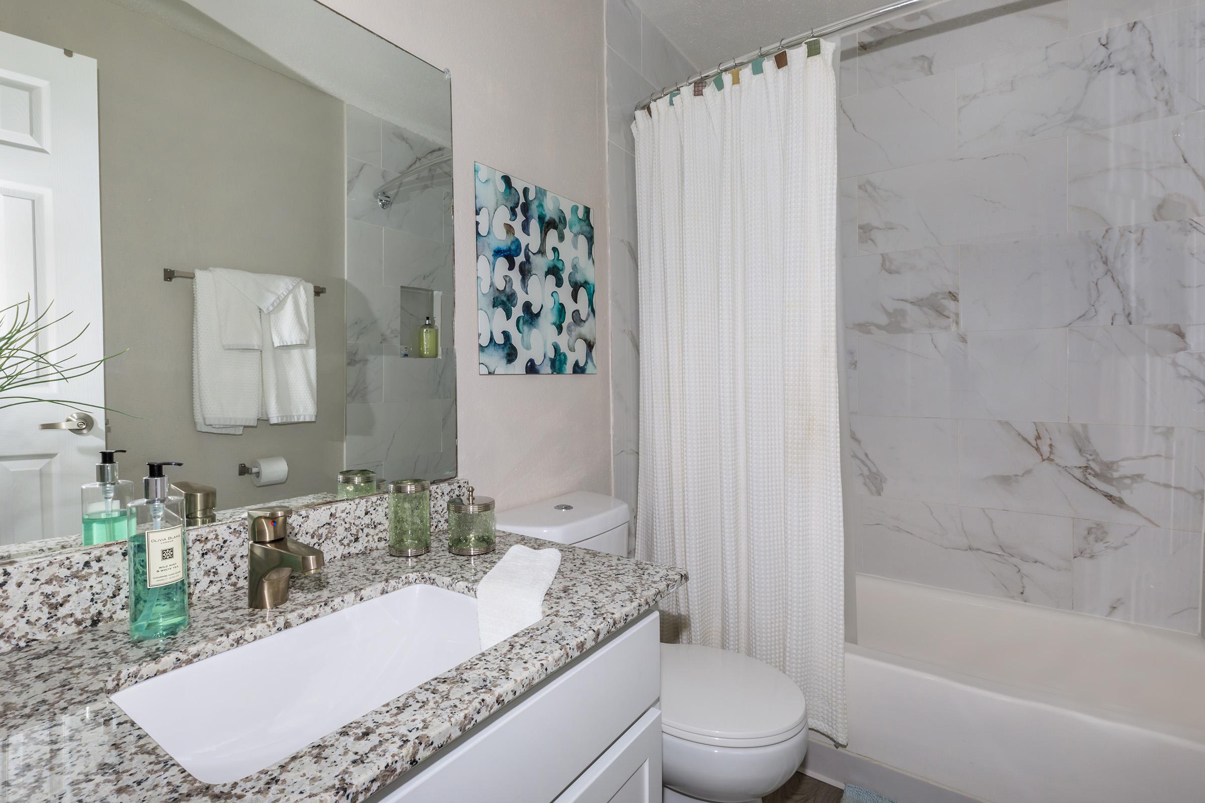 a large white tub next to a sink