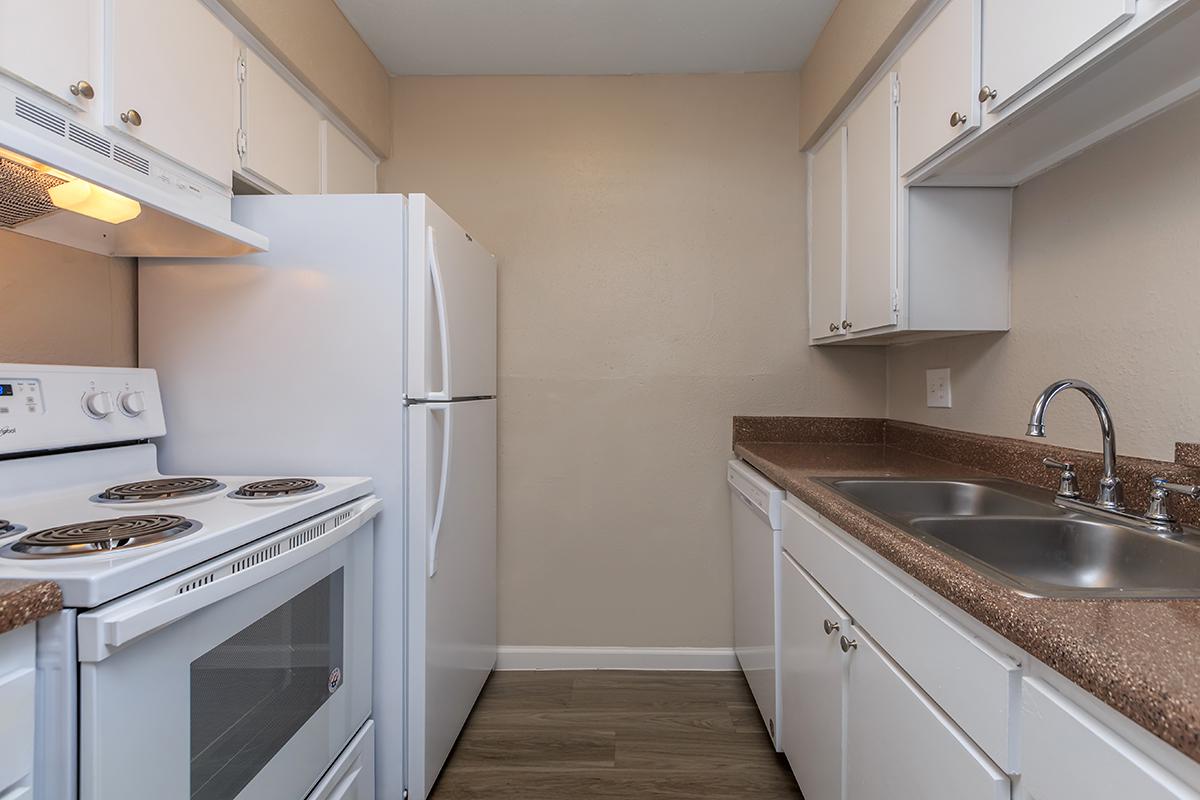 a kitchen with a white stove top oven