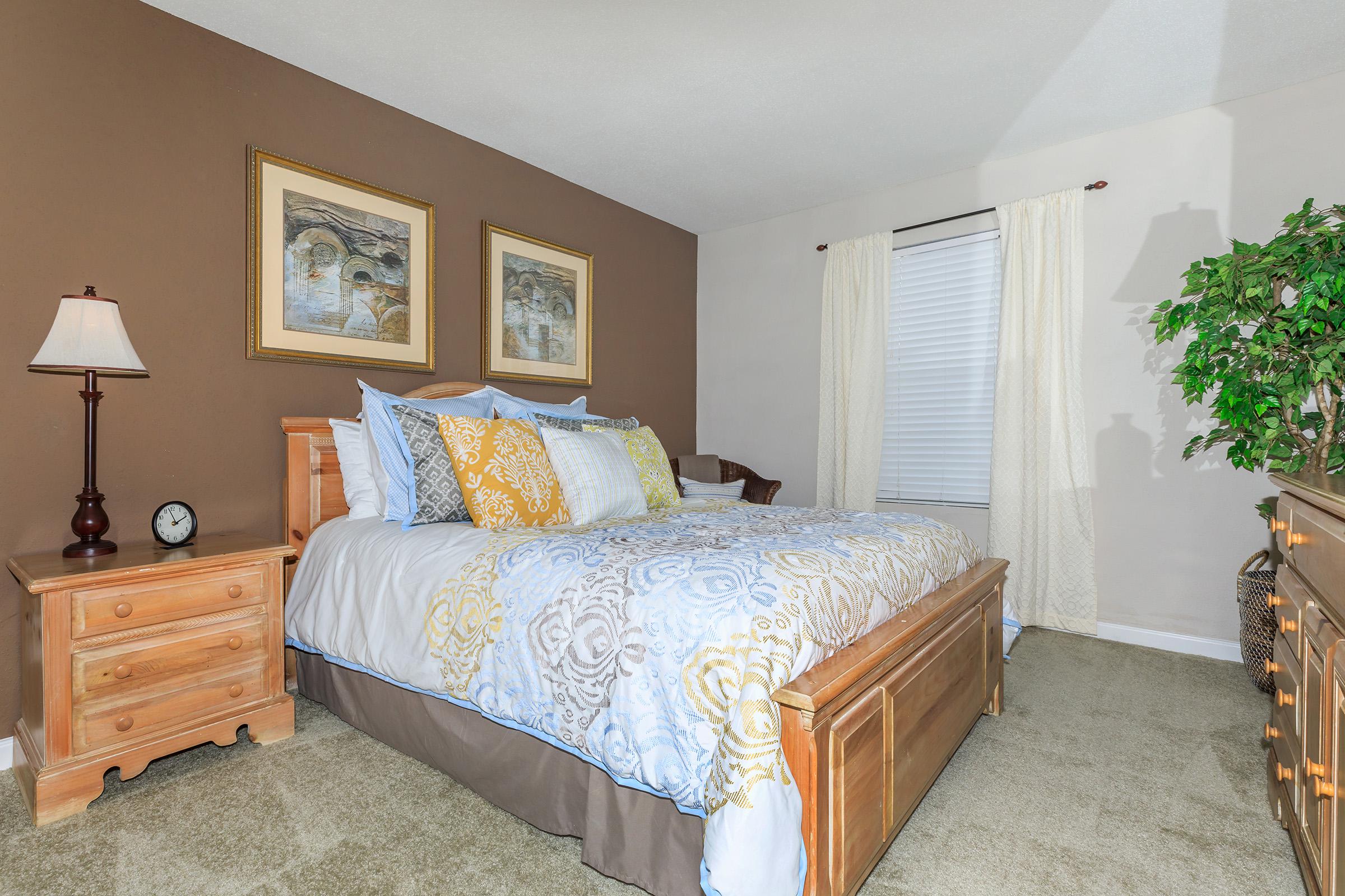 a bedroom with a bed and desk in a room