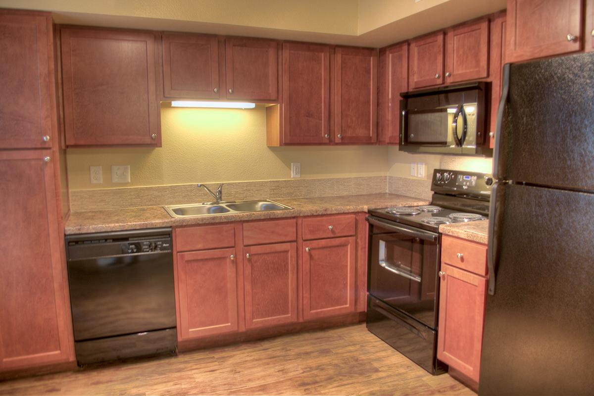 a kitchen with stainless steel appliances and wooden cabinets