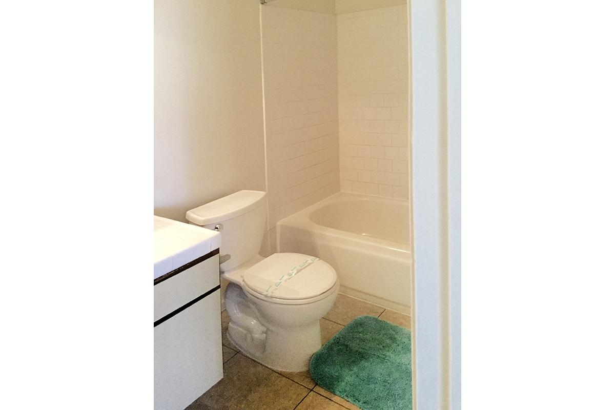 a white tub sitting next to a sink
