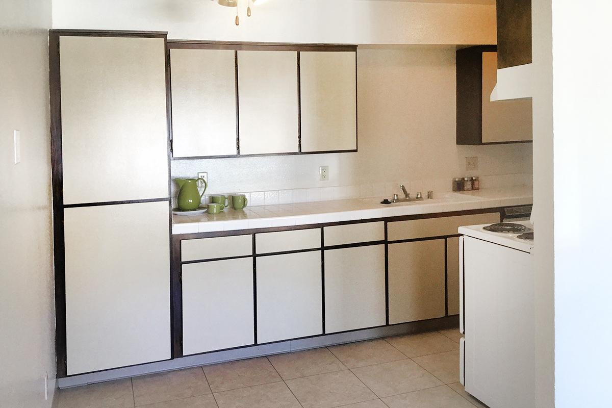 a white refrigerator freezer sitting inside of a kitchen