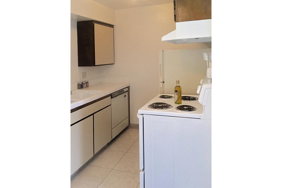 a white stove top oven sitting inside of a kitchen