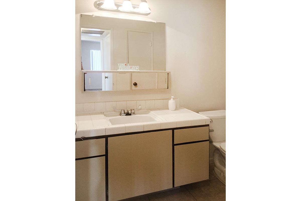 a white sink and a mirror