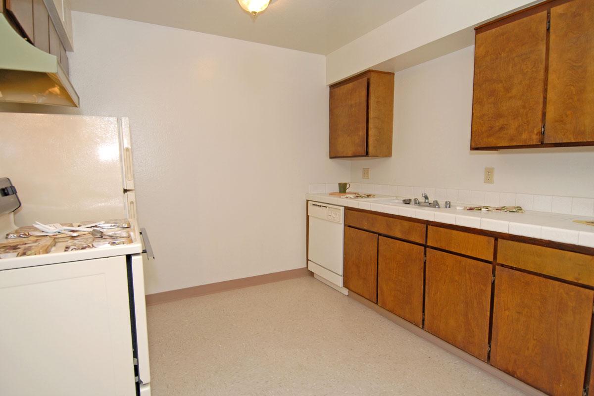 a kitchen with a stove sink and refrigerator