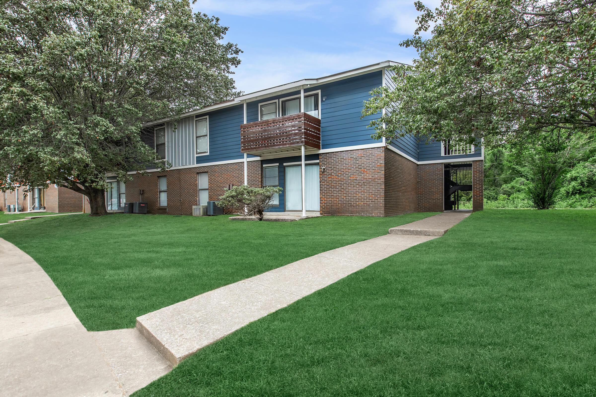 a house with a lawn in front of a building