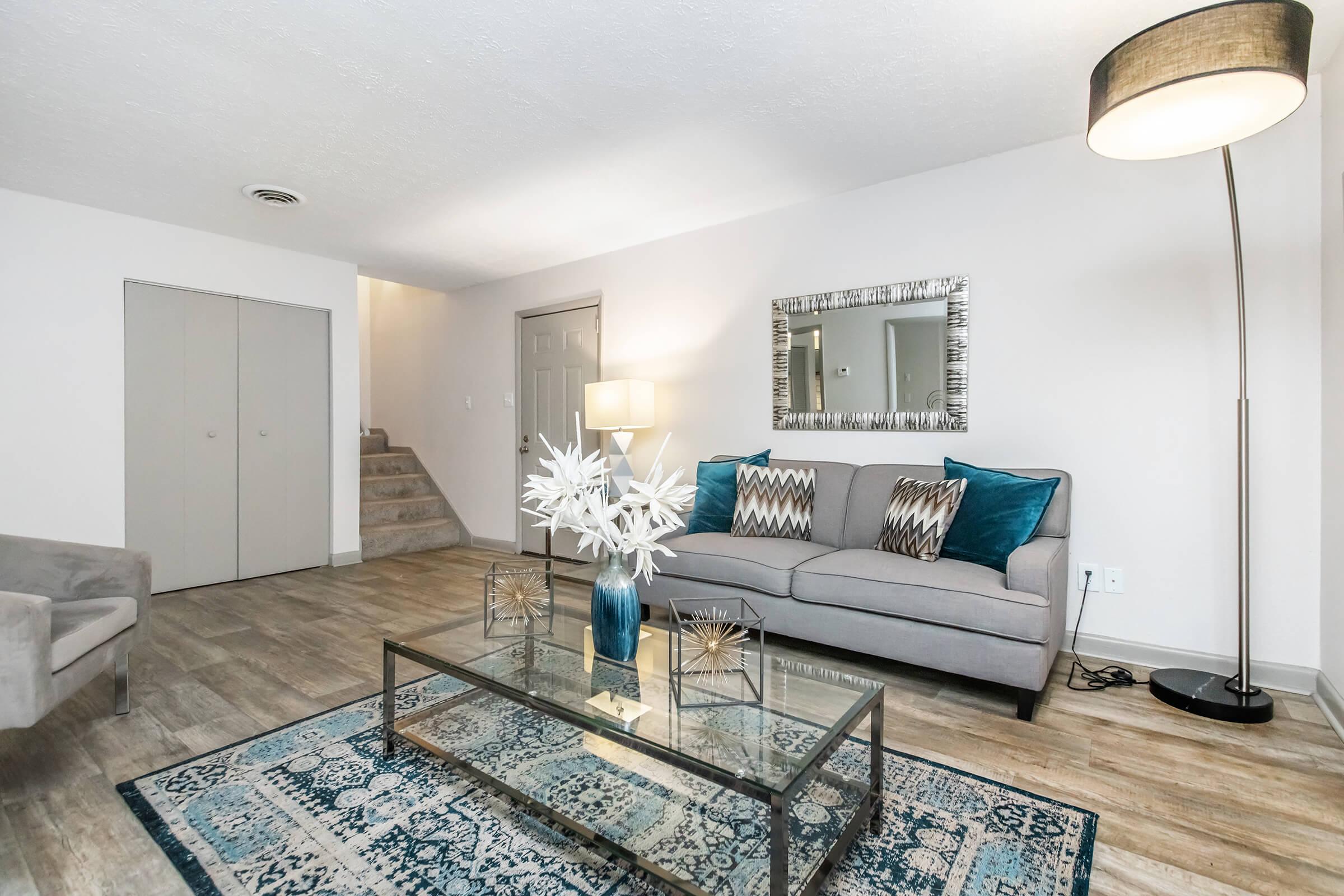 a living room filled with furniture and a rug