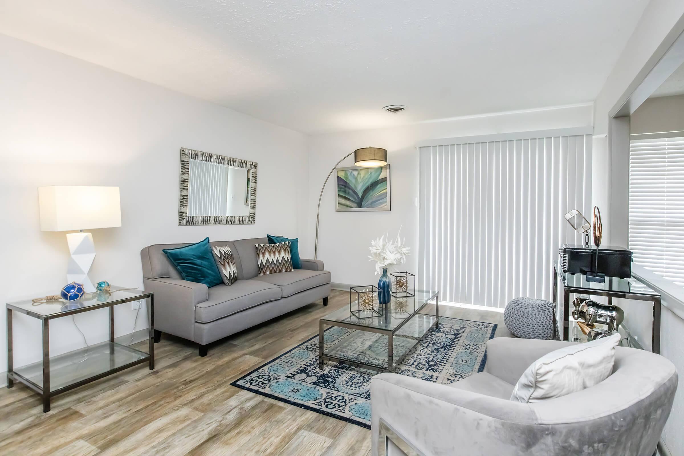 a living room filled with furniture and a large window