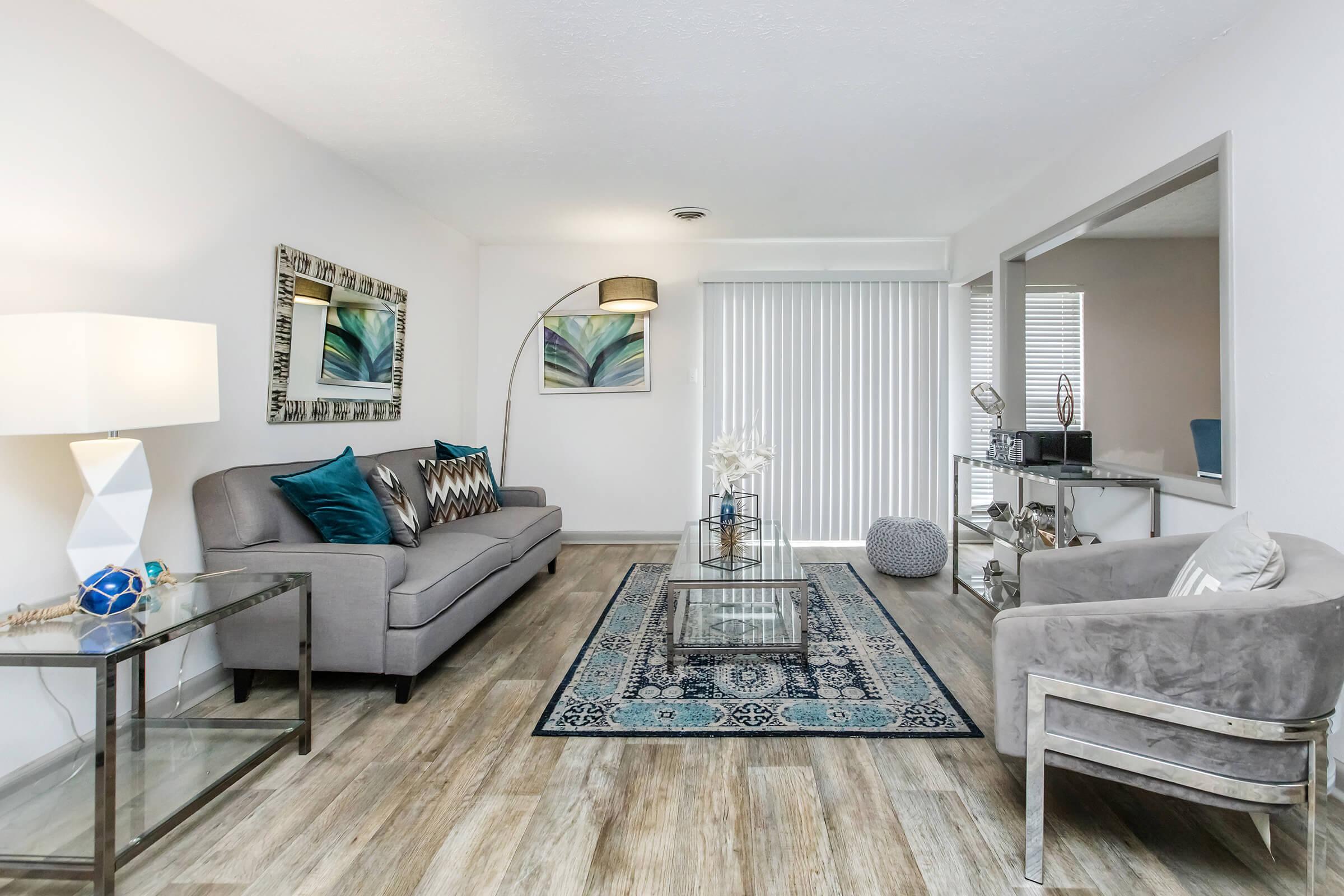 a living room filled with furniture and a large window