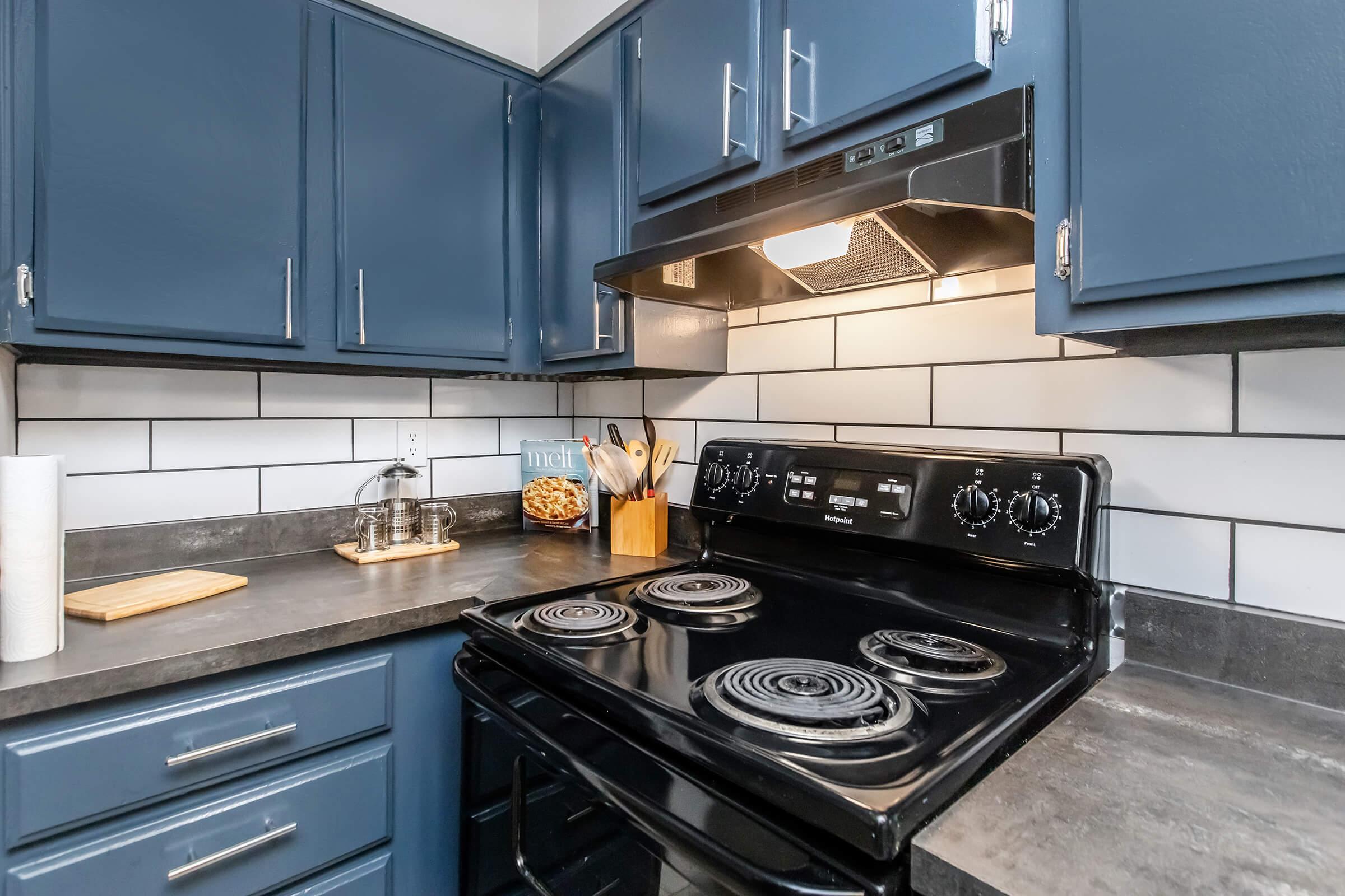 a stove top oven sitting inside of a kitchen