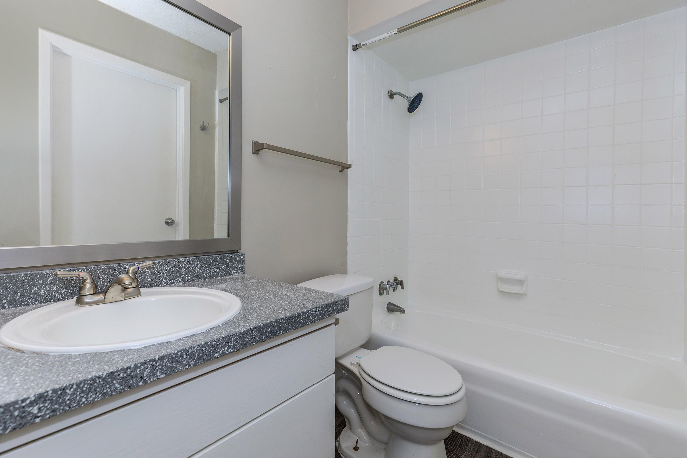 a large white tub next to a sink