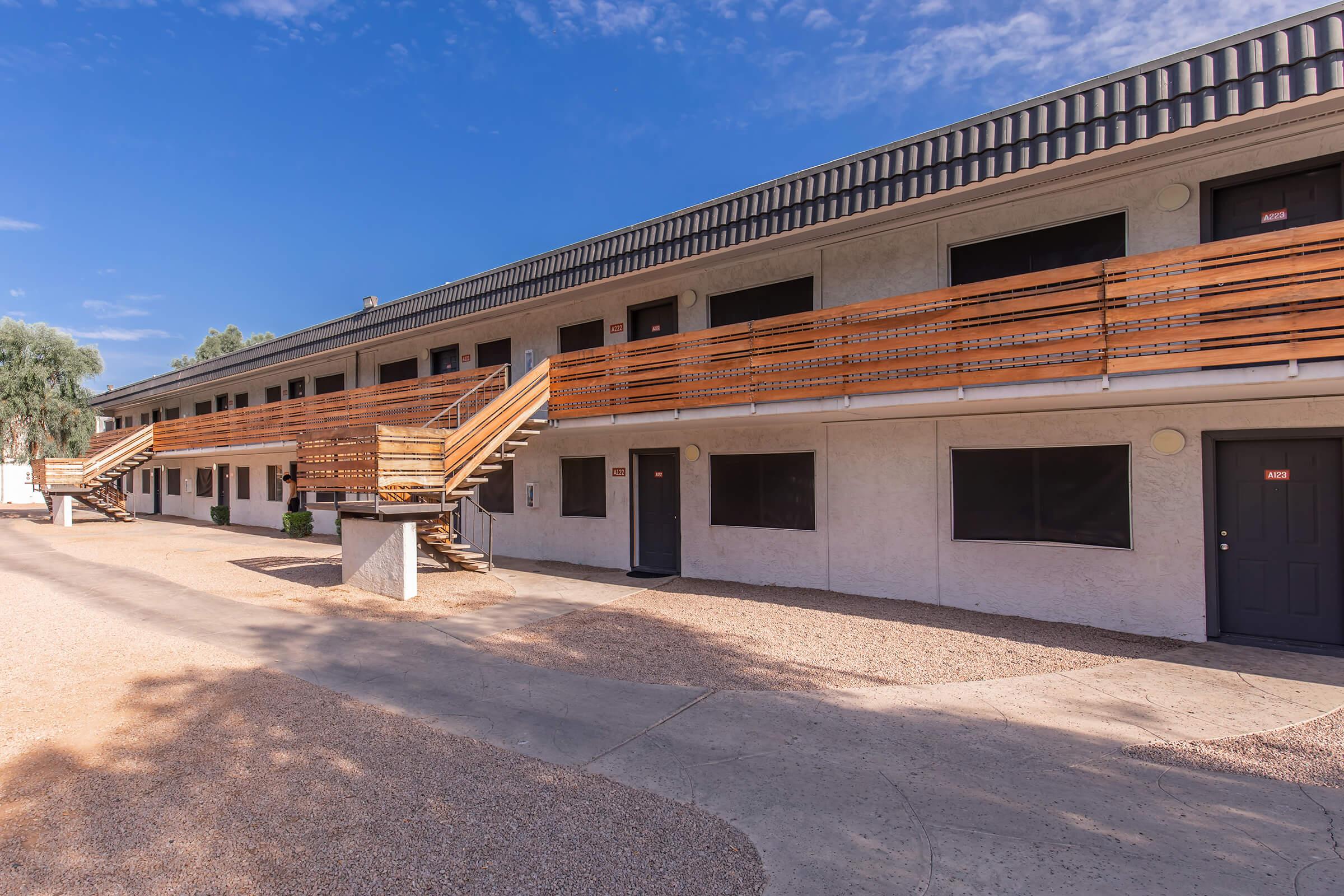 a dirt road in front of a building