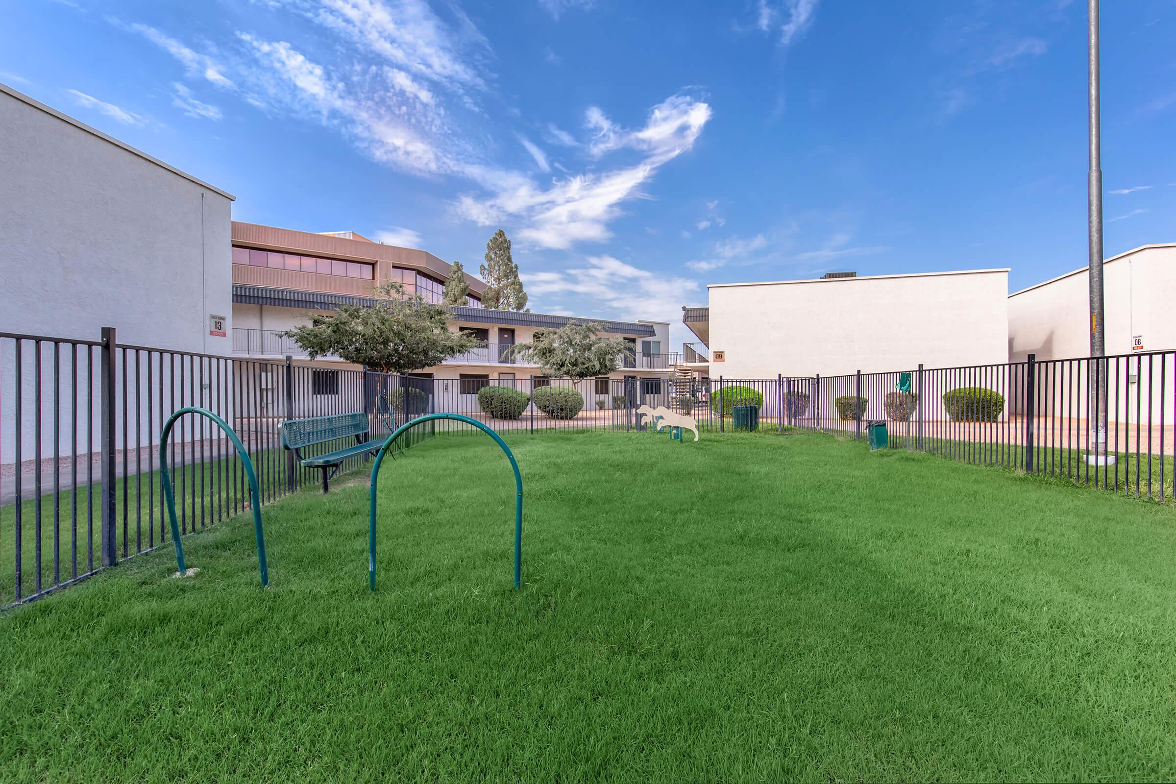 a house with a fence in front of a building