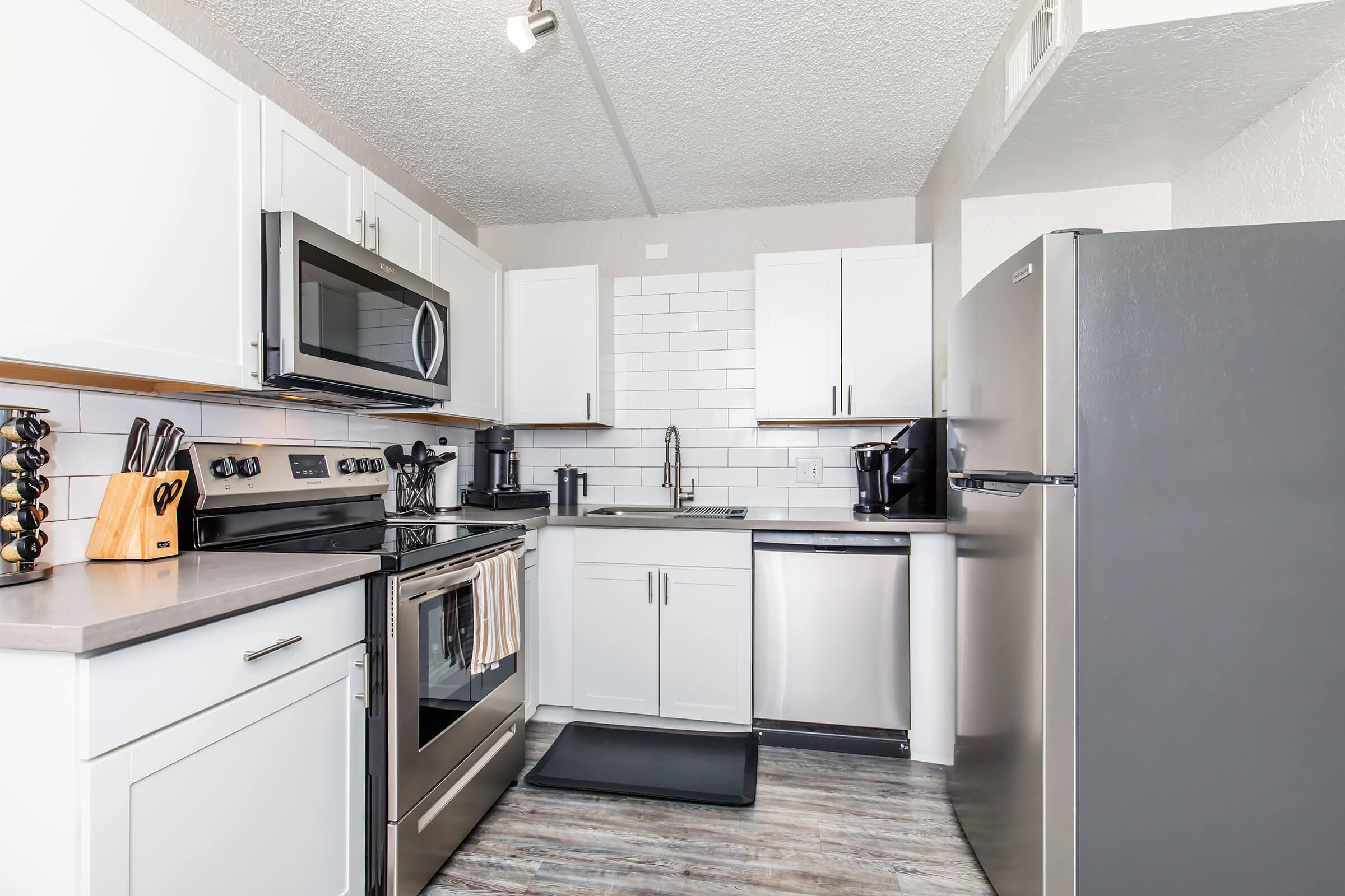 a kitchen with a stove and a refrigerator