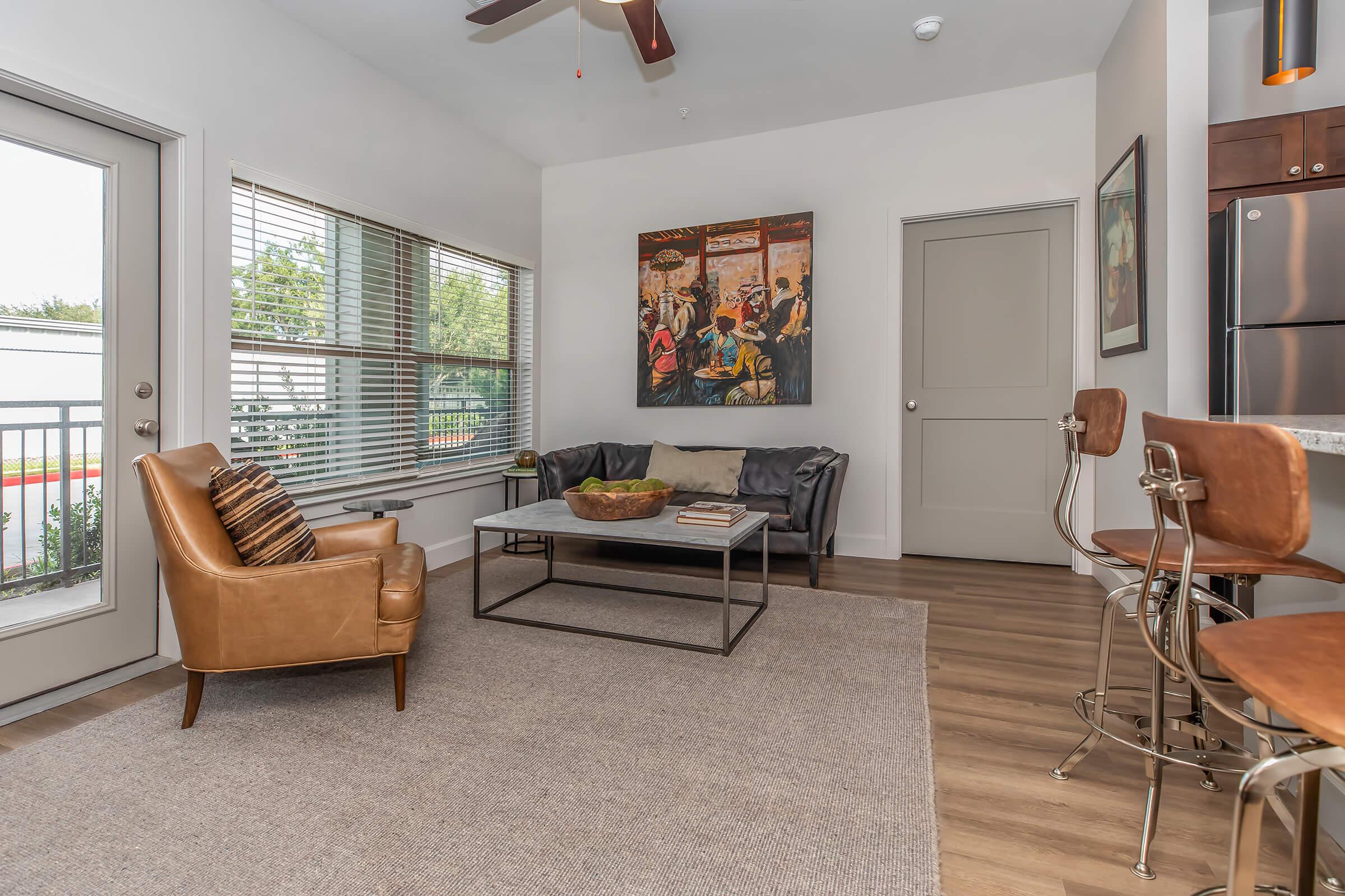 a living room filled with furniture and a large window