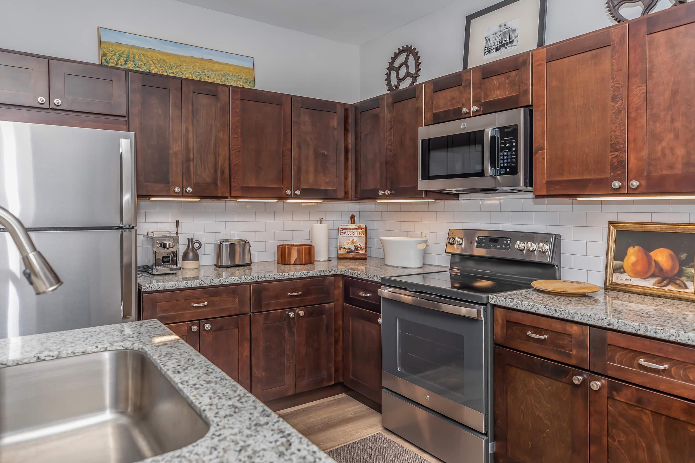 a kitchen with stainless steel appliances and wooden cabinets