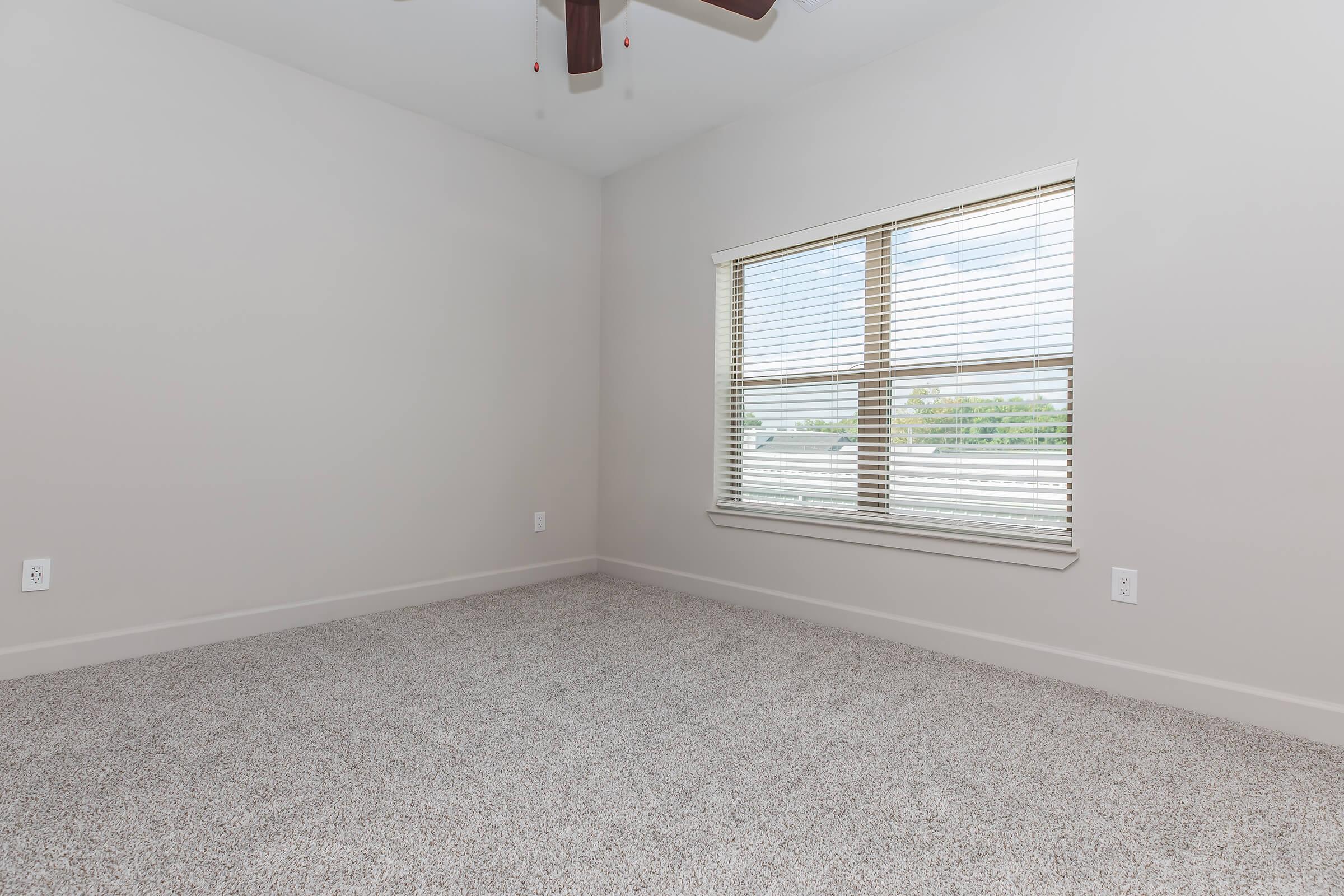 a bedroom with a large window