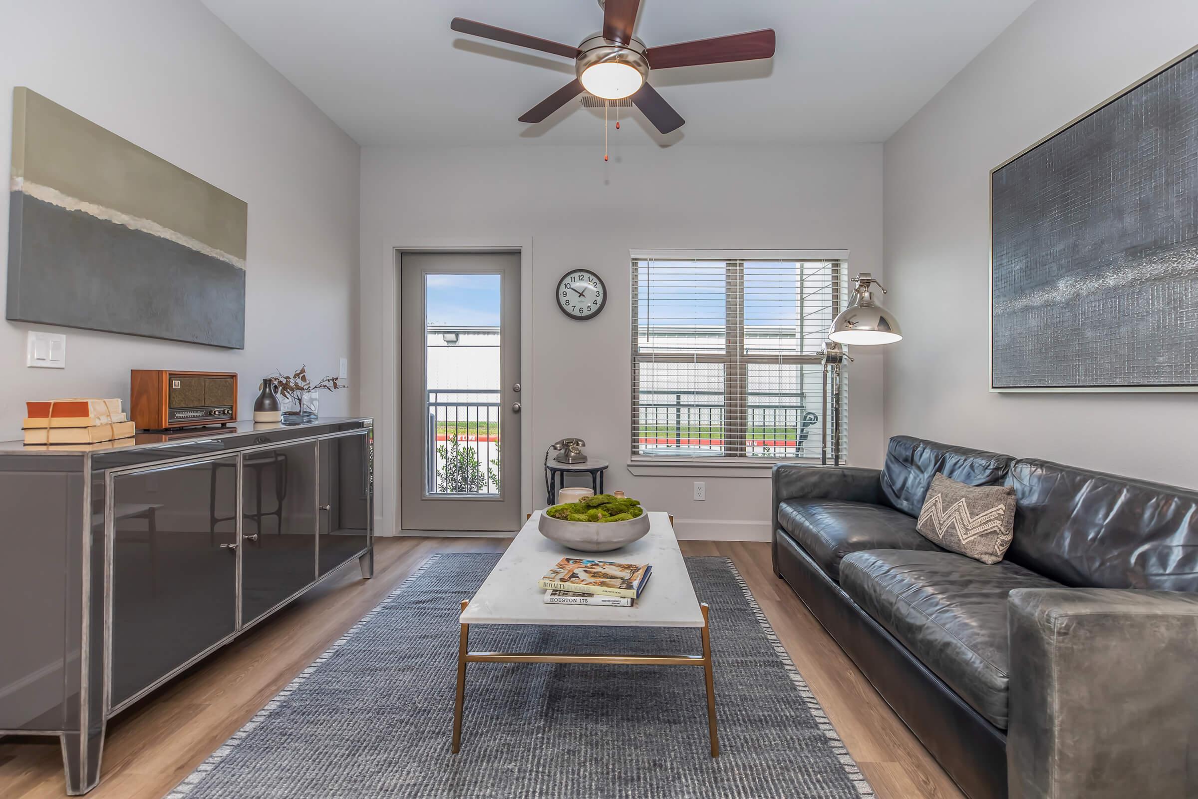 a living room filled with furniture and a large window