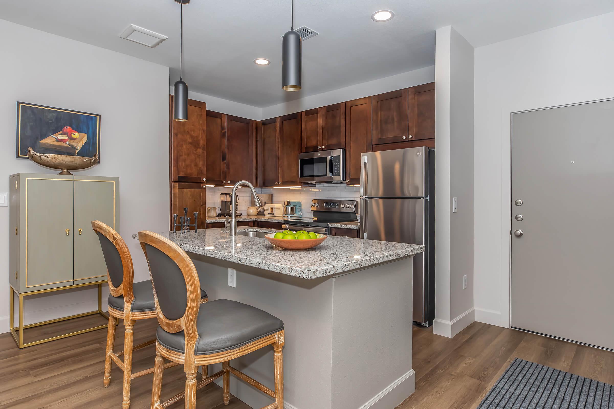 a kitchen with an island in the middle of a room