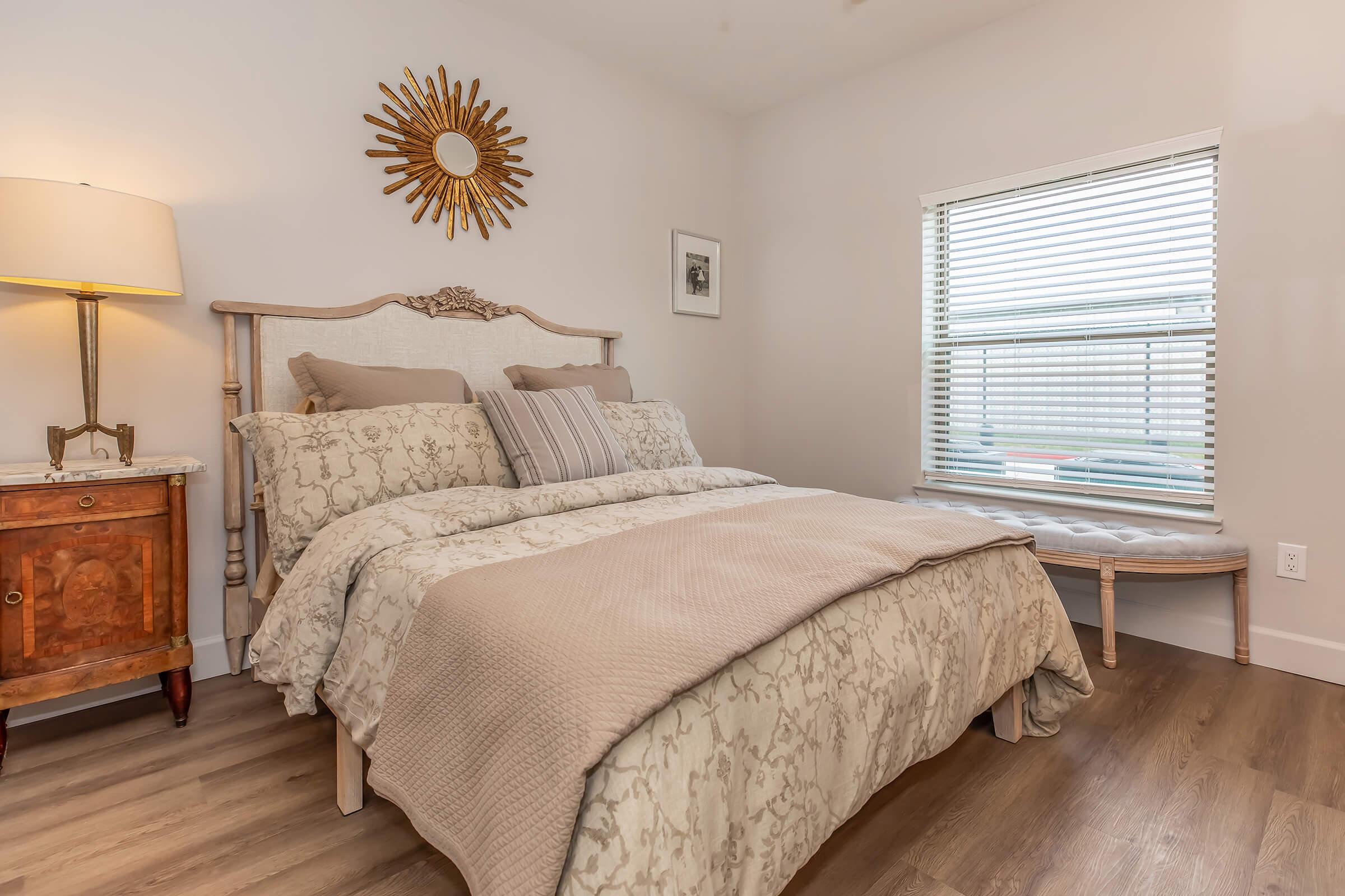 a bedroom with a bed and desk in a room