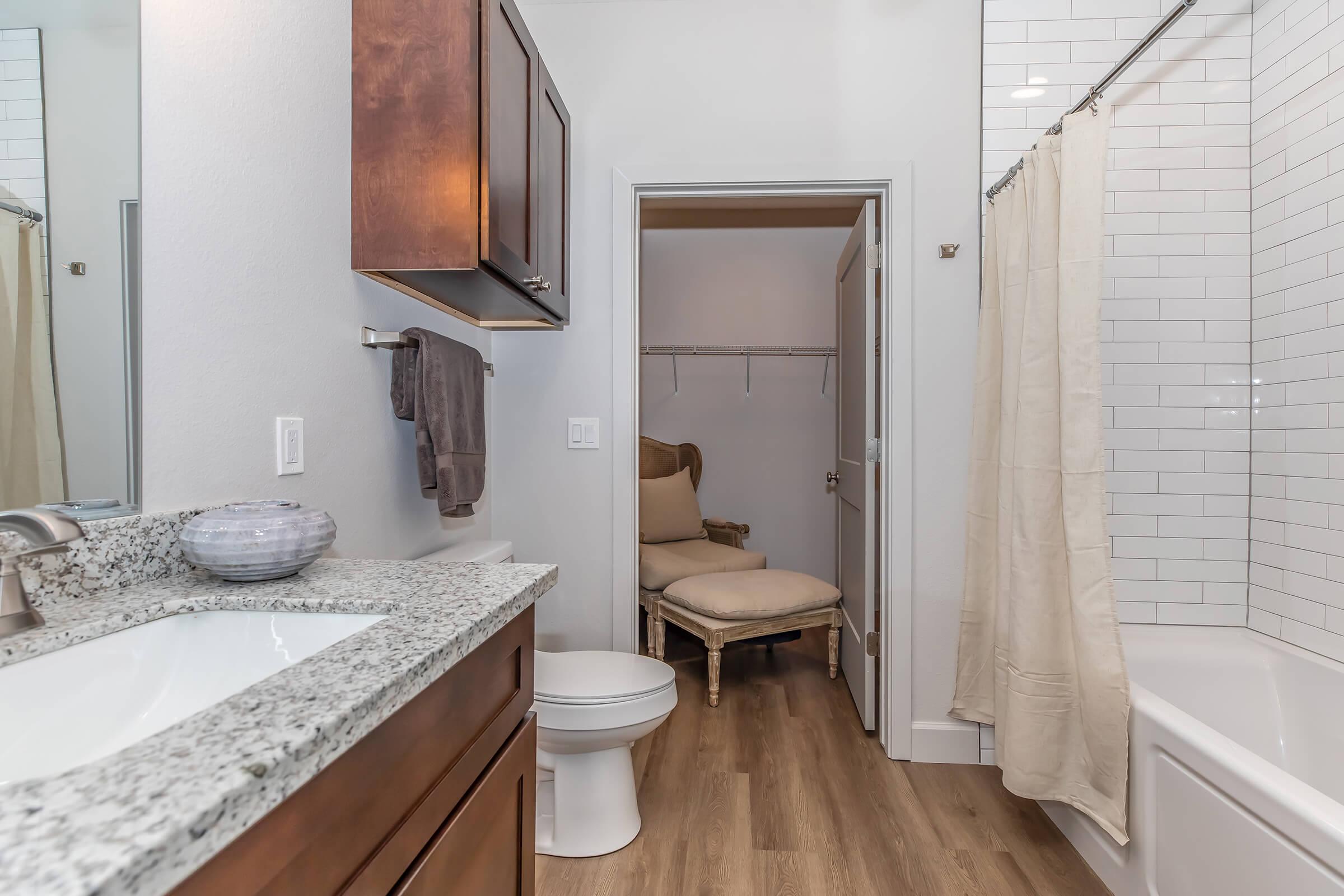 a bedroom with a shower and a sink