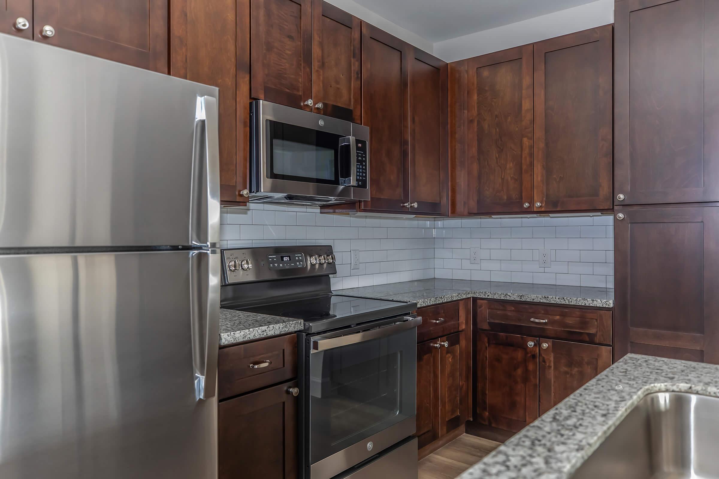 a kitchen with stainless steel appliances and wooden cabinets