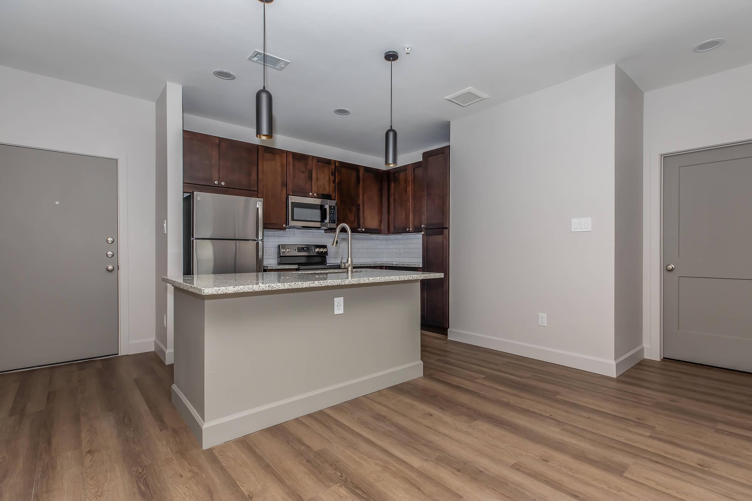 a kitchen with a wood floor