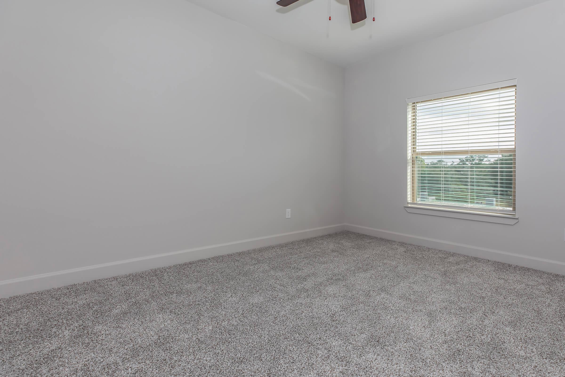 a bedroom with a large window