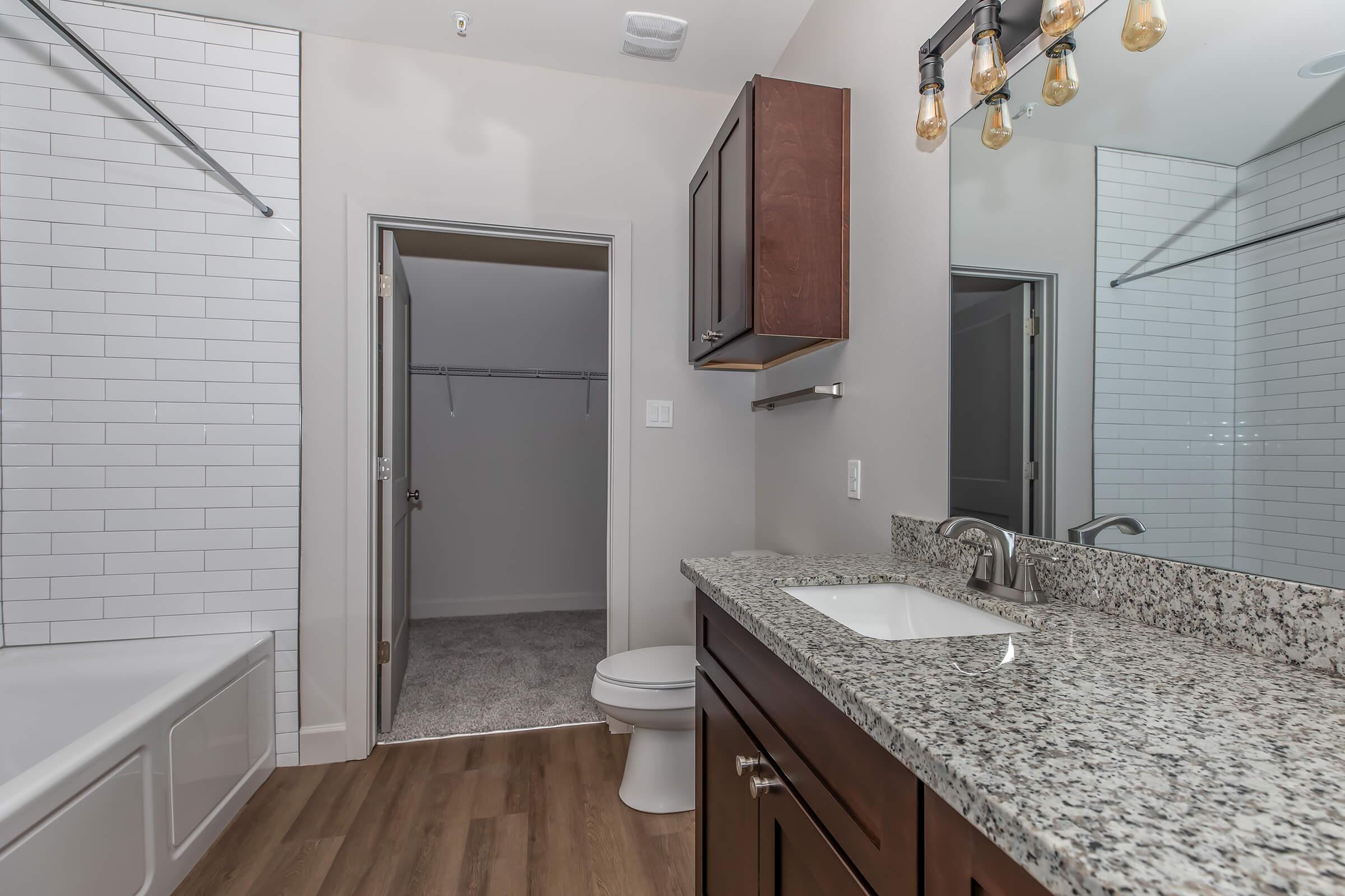 a kitchen with a sink and a mirror