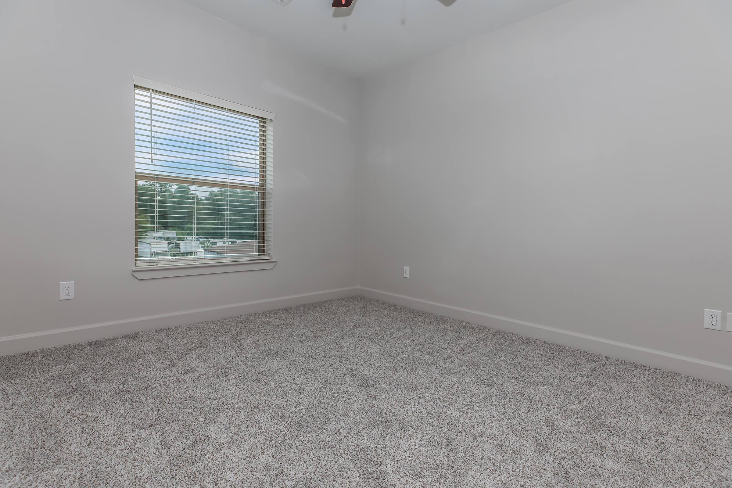 a bedroom with a large window