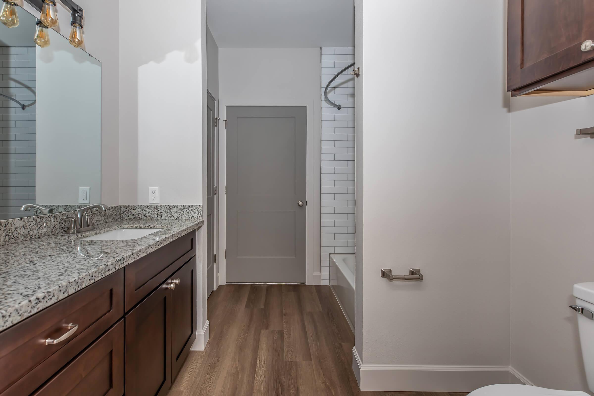 a kitchen with a sink and a mirror