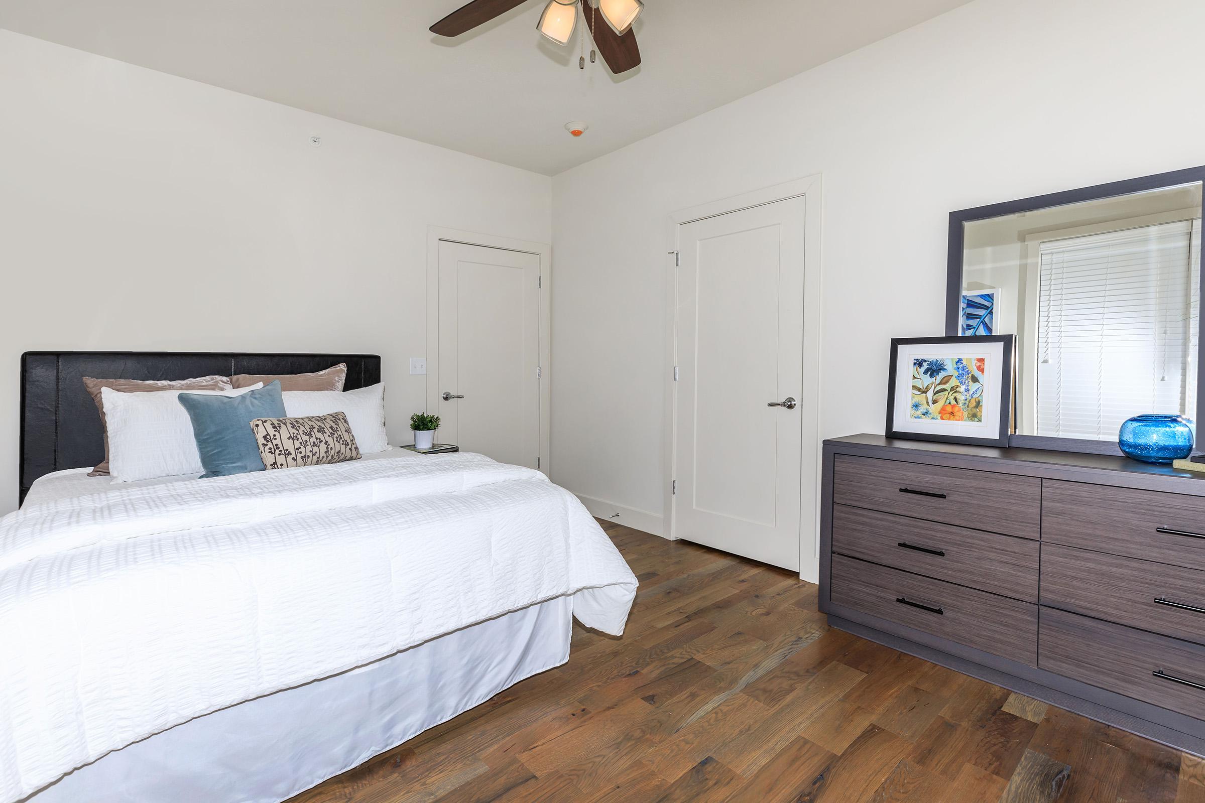 a bedroom with a bed and desk in a room