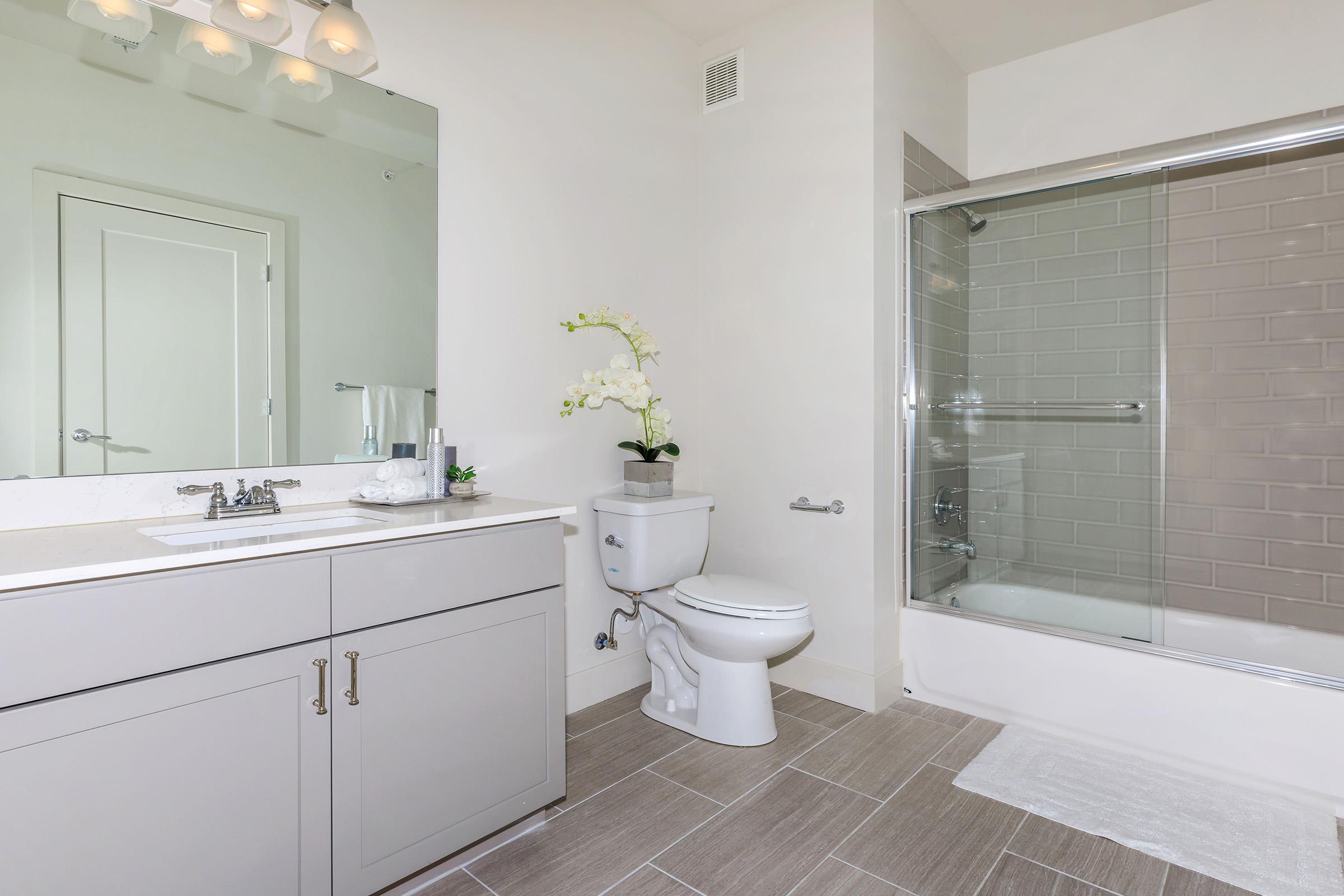 a large white tub next to a sink