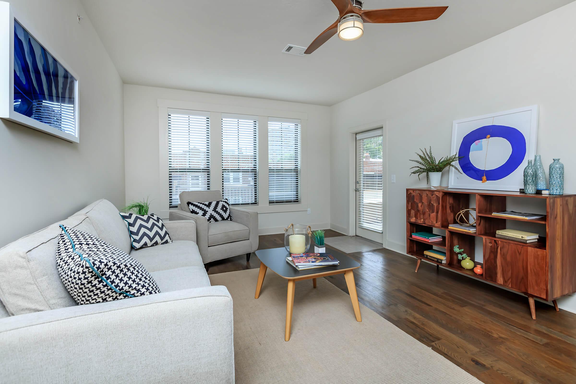 a living room filled with furniture and a flat screen tv