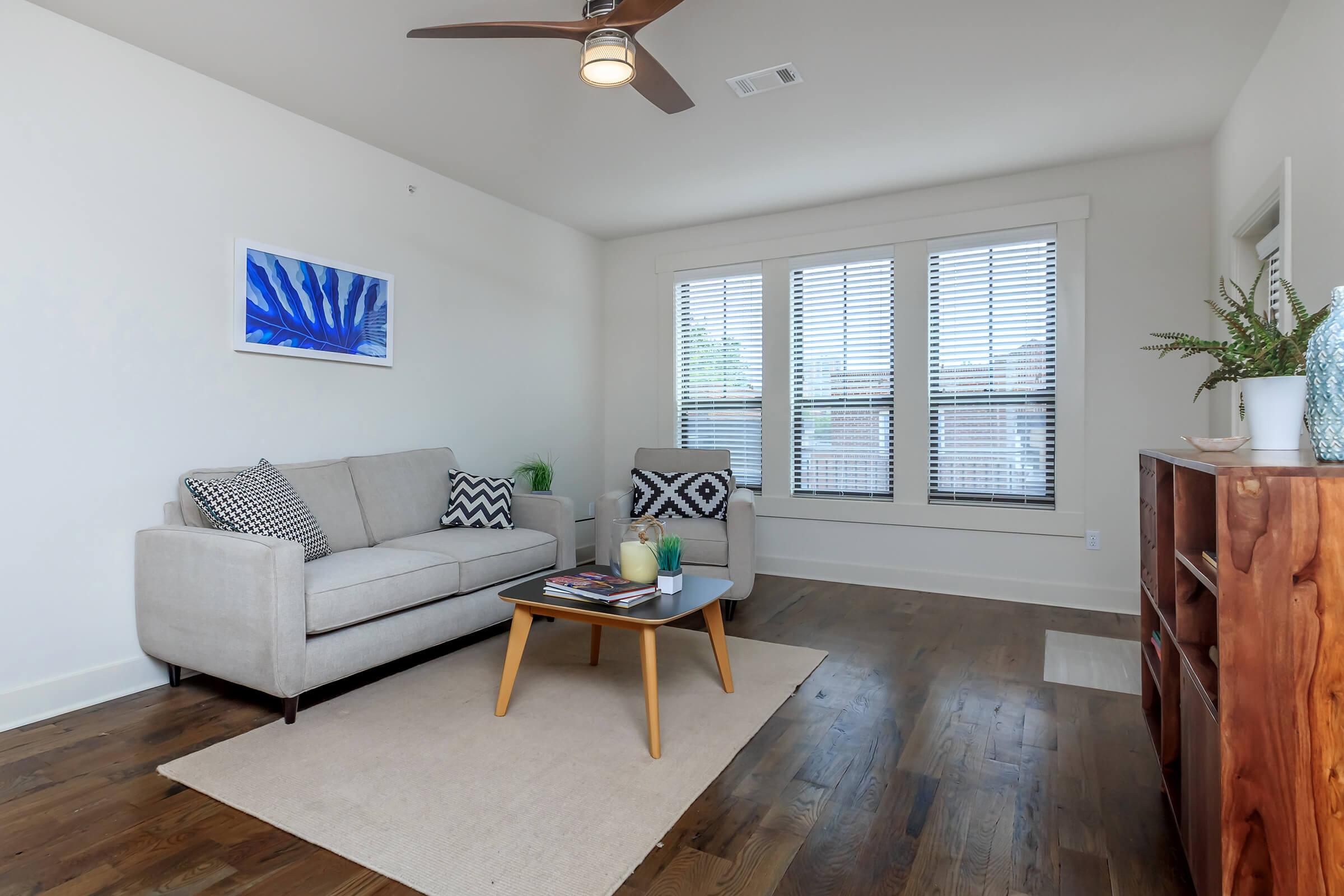 a living room filled with furniture and a large window