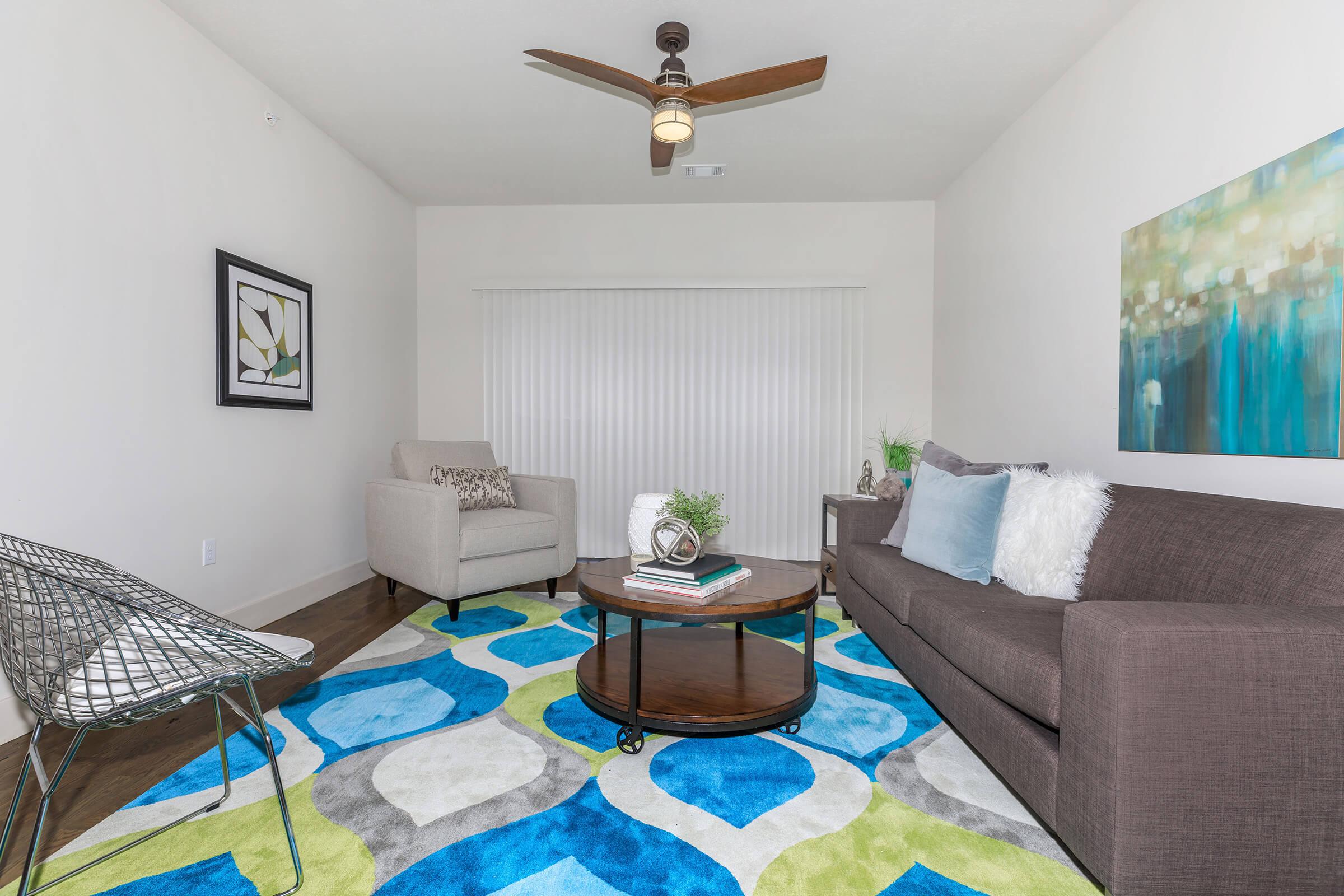 a living room filled with furniture and a rug