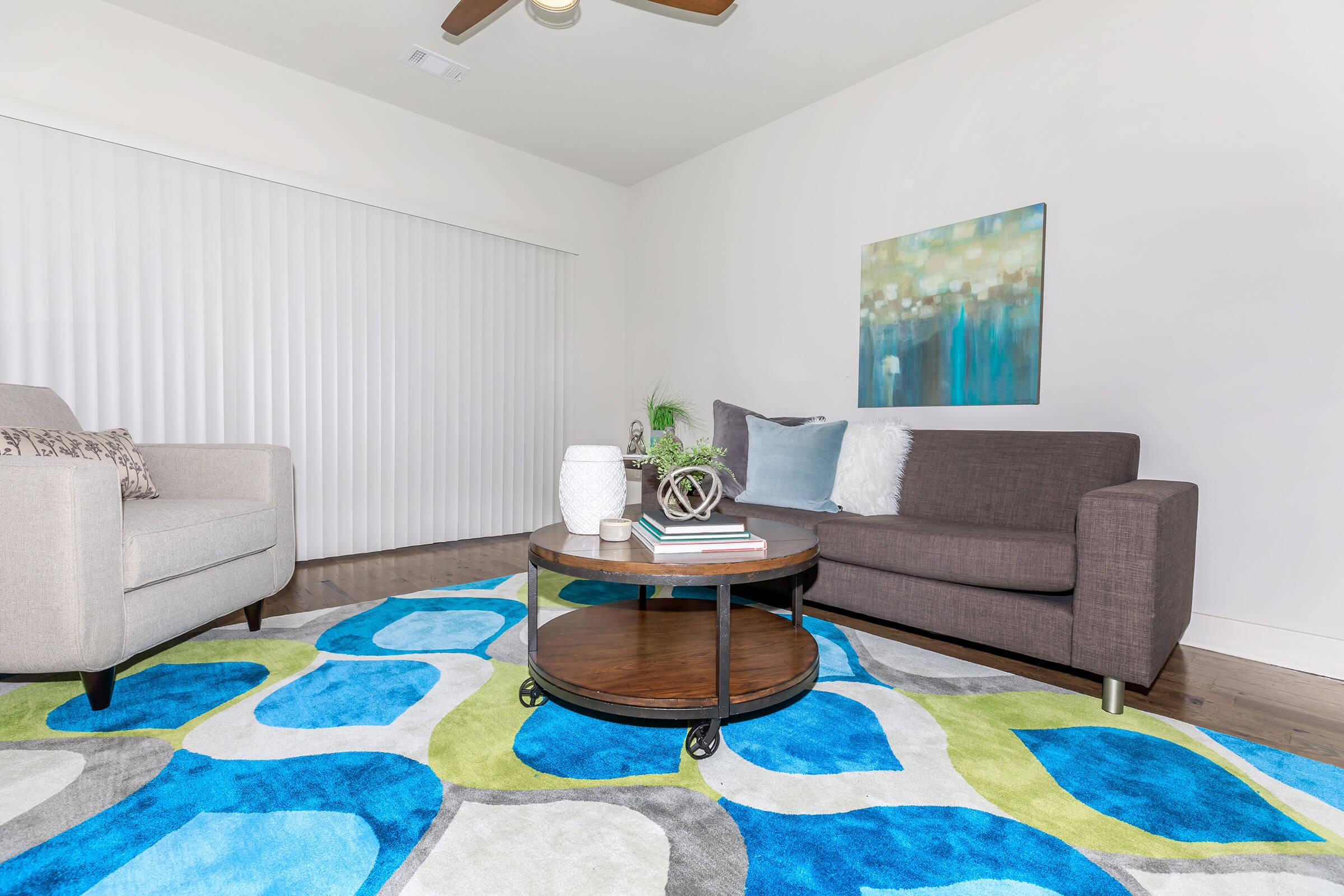 a living room filled with furniture and a rug