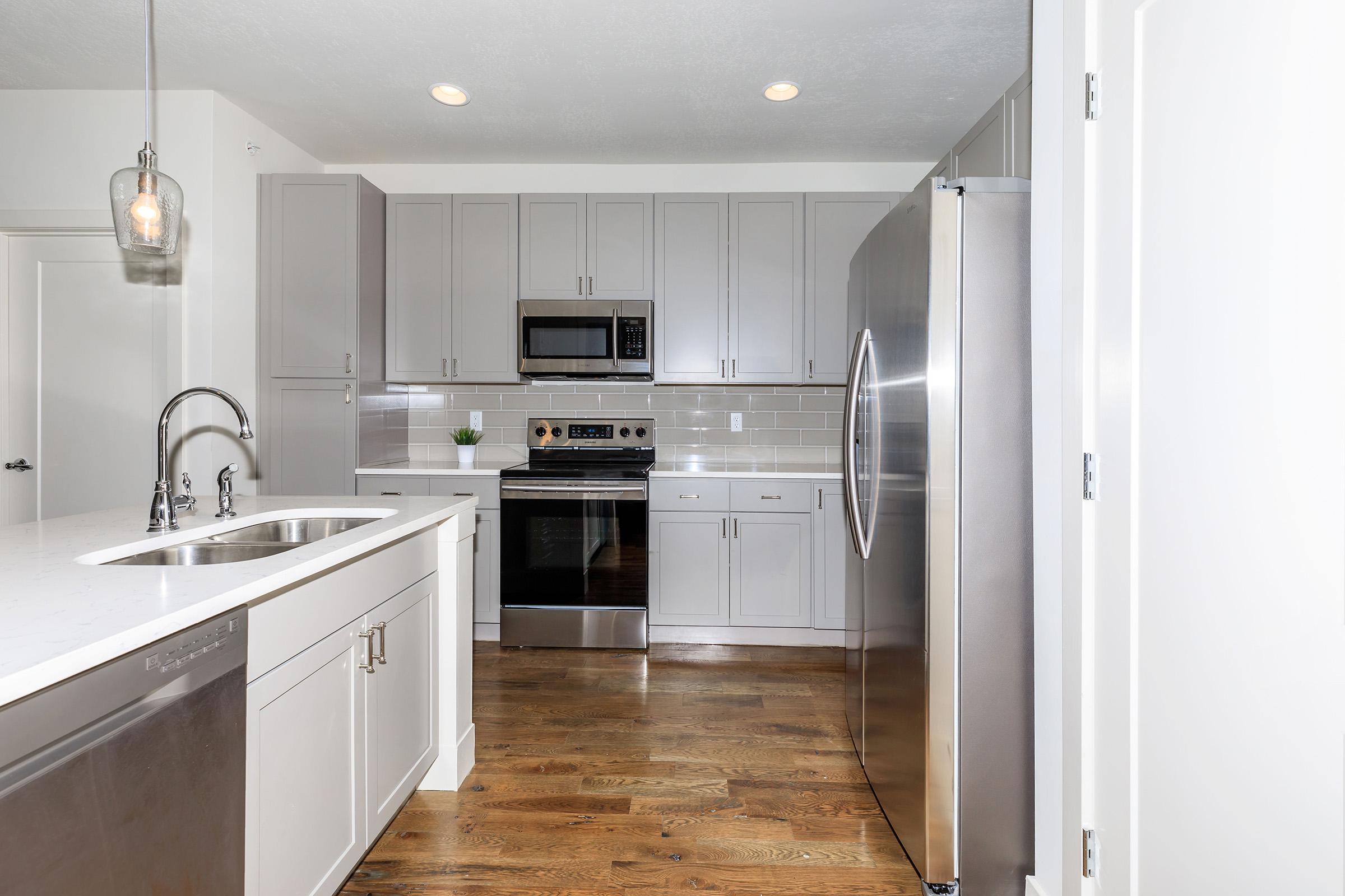 a large kitchen with stainless steel appliances