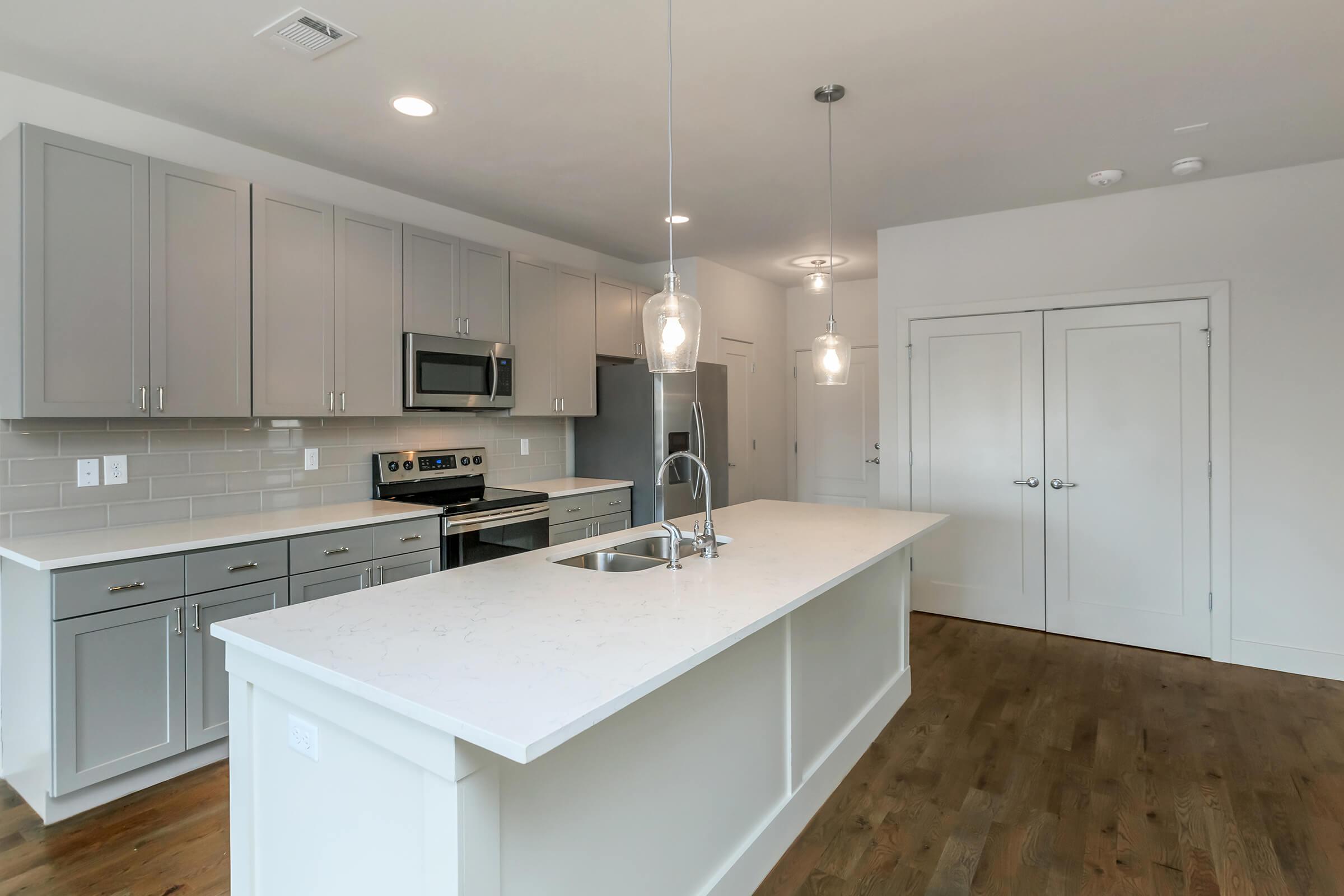 a kitchen with an island in the middle of a room