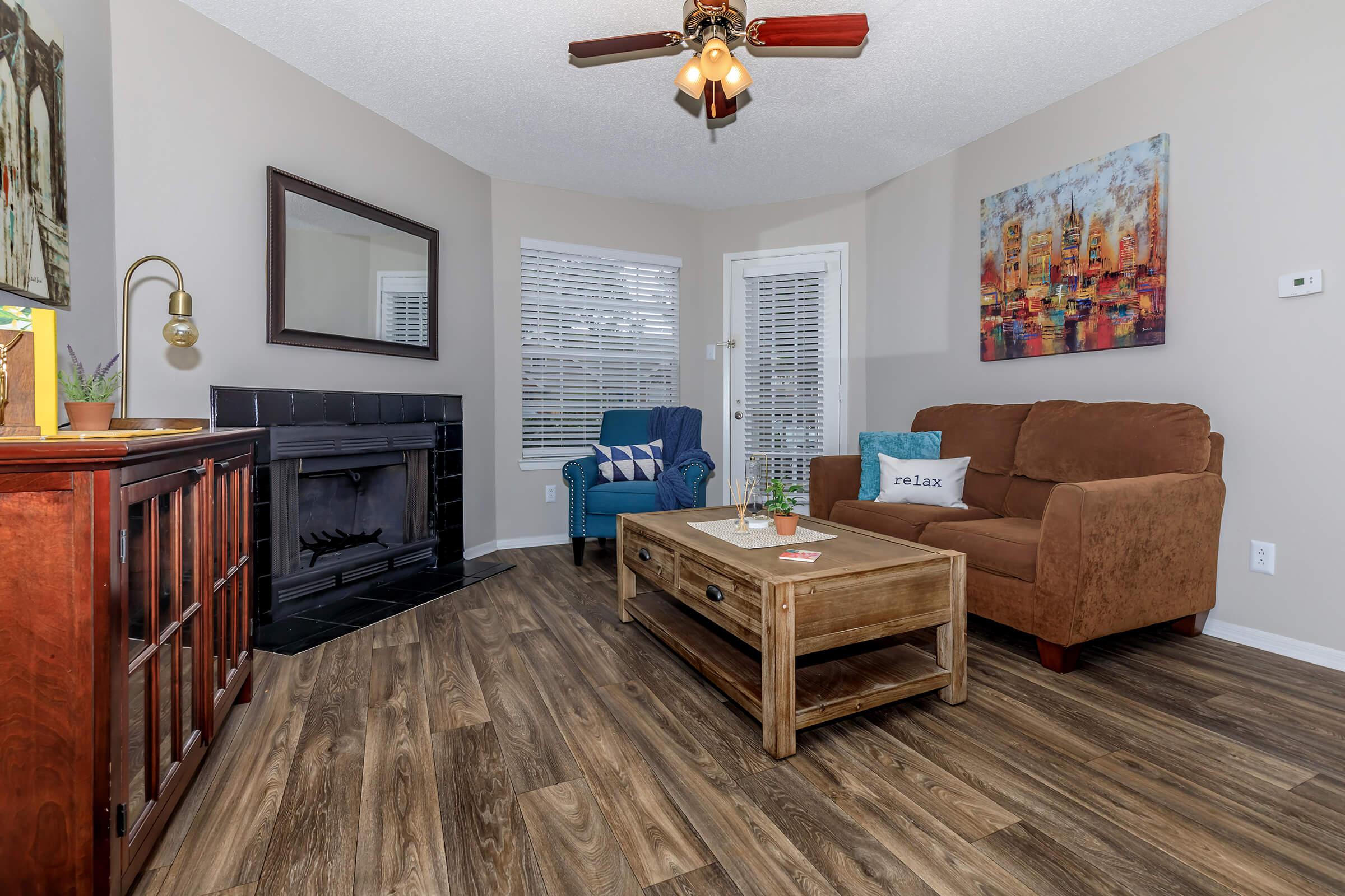 a living room filled with furniture and a fireplace