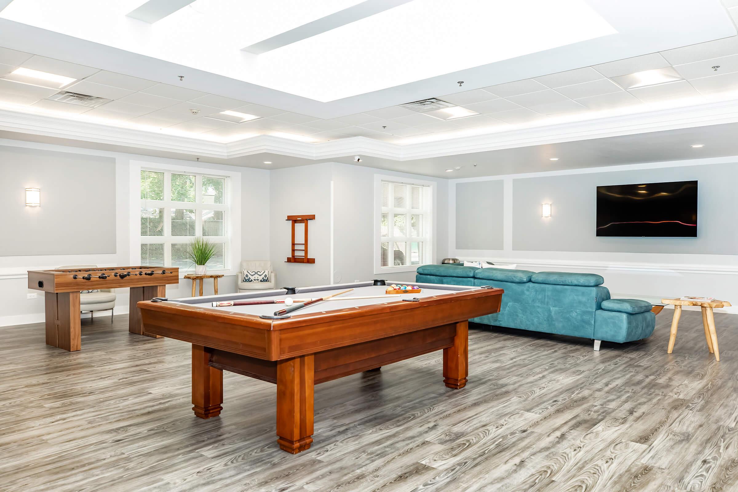 a living room filled with furniture on top of a wooden table