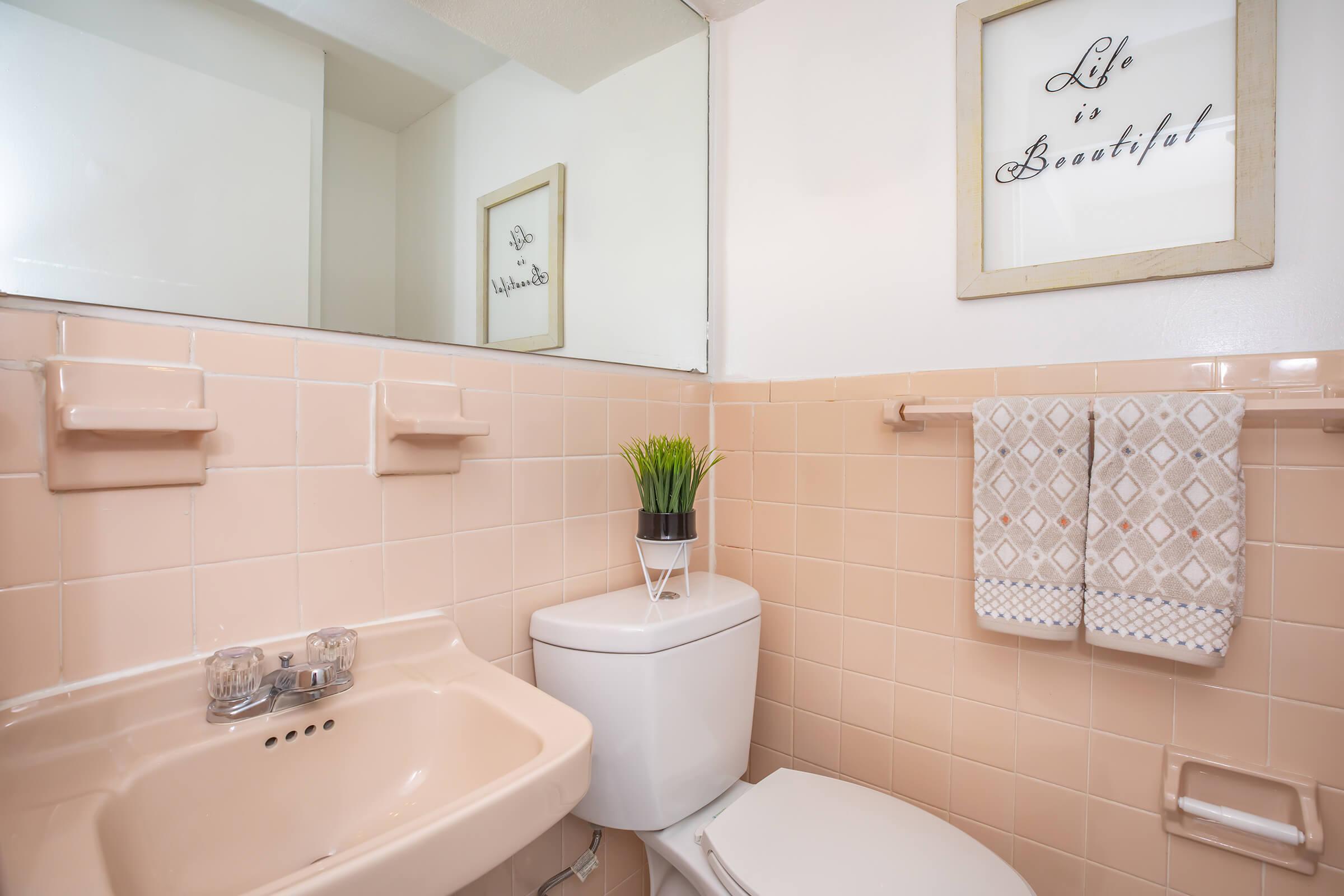 a group of pink tub and sink