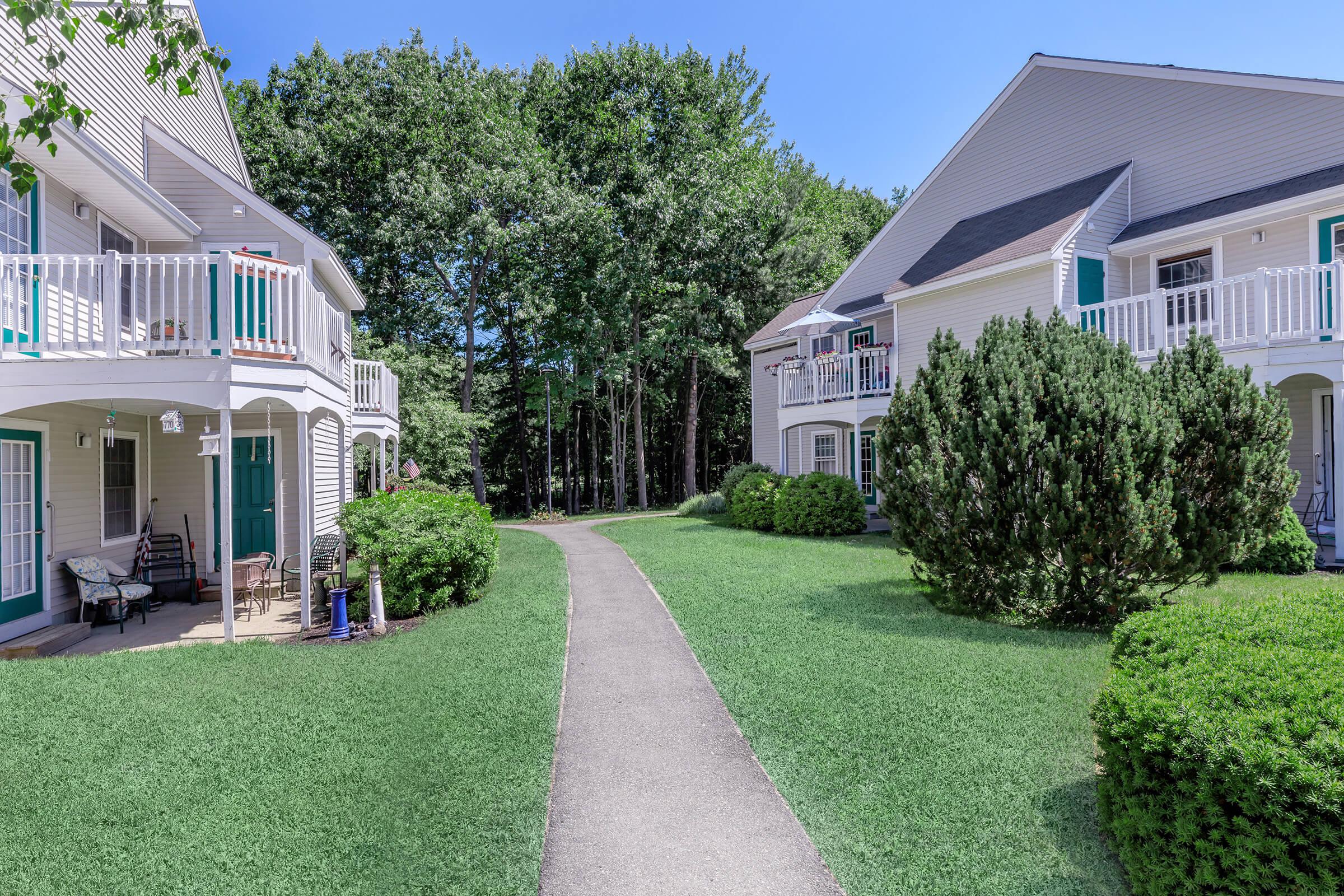 a house with a lawn in front of a building