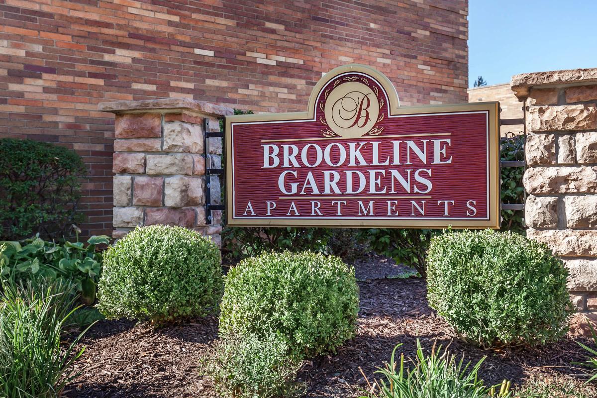 a sign in front of a brick building