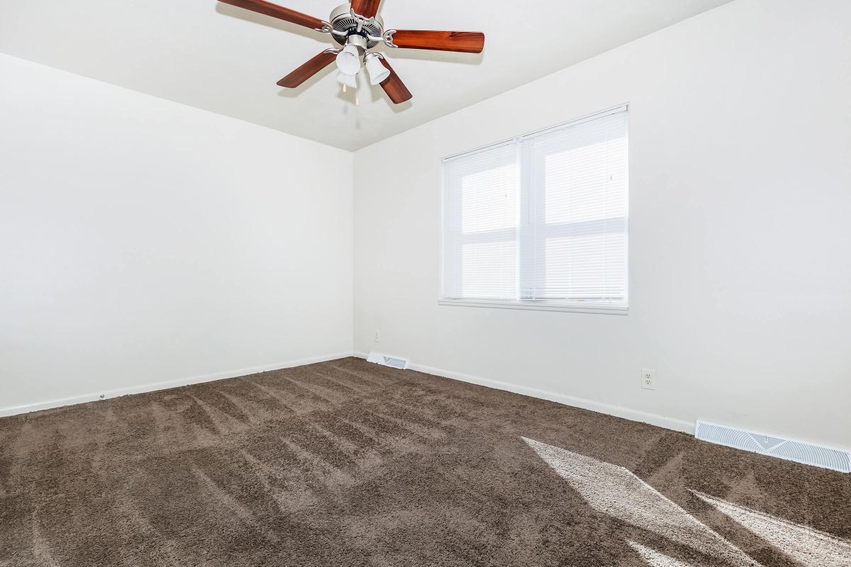 a bedroom with a large window