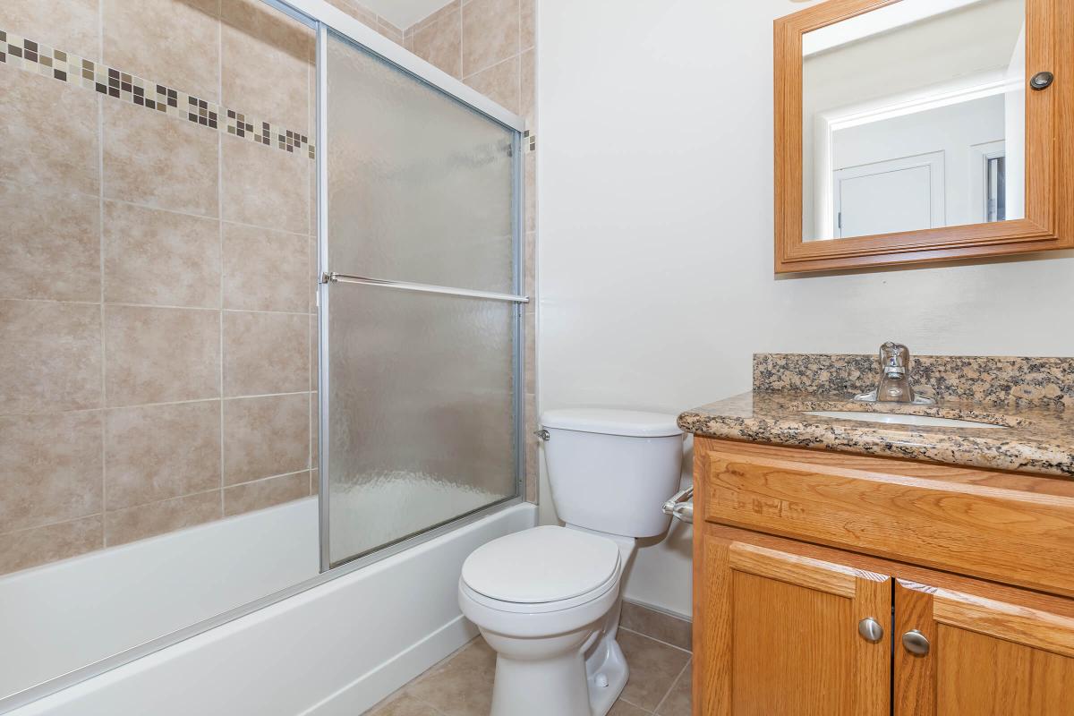 a white tub sitting next to a shower