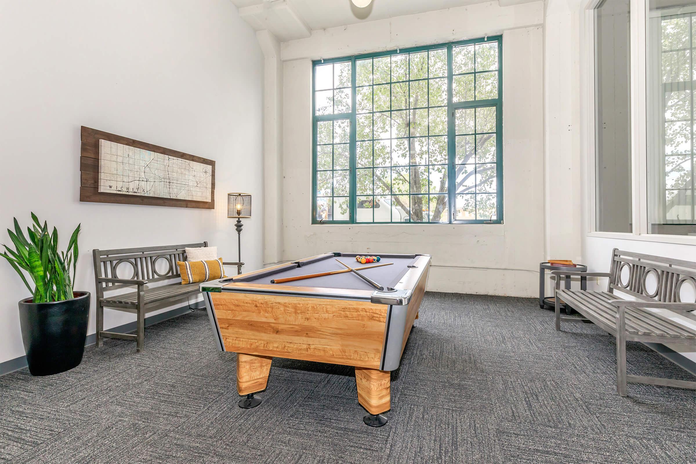 a living room filled with furniture and a large window