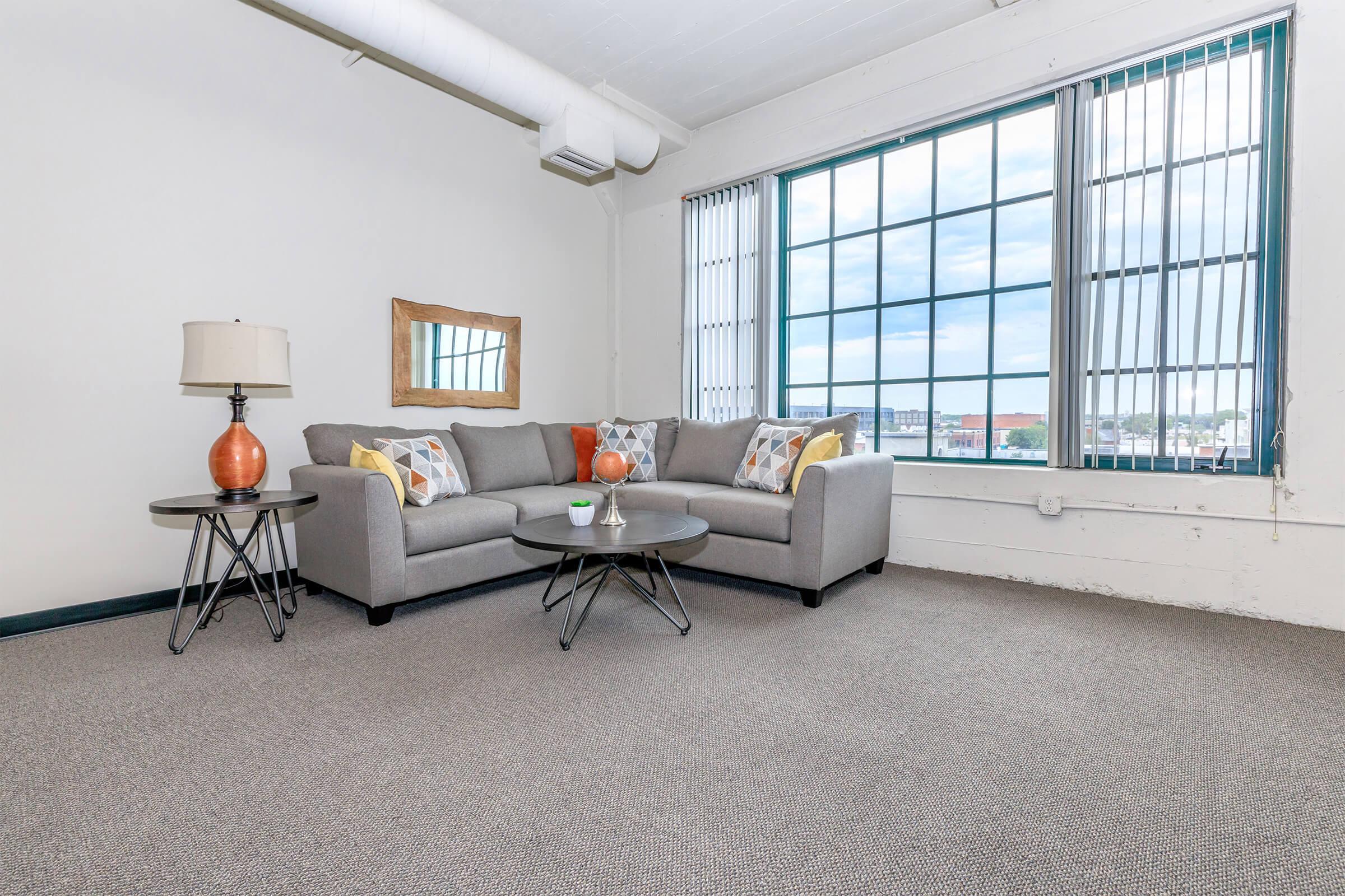 a living room with a bed and a window