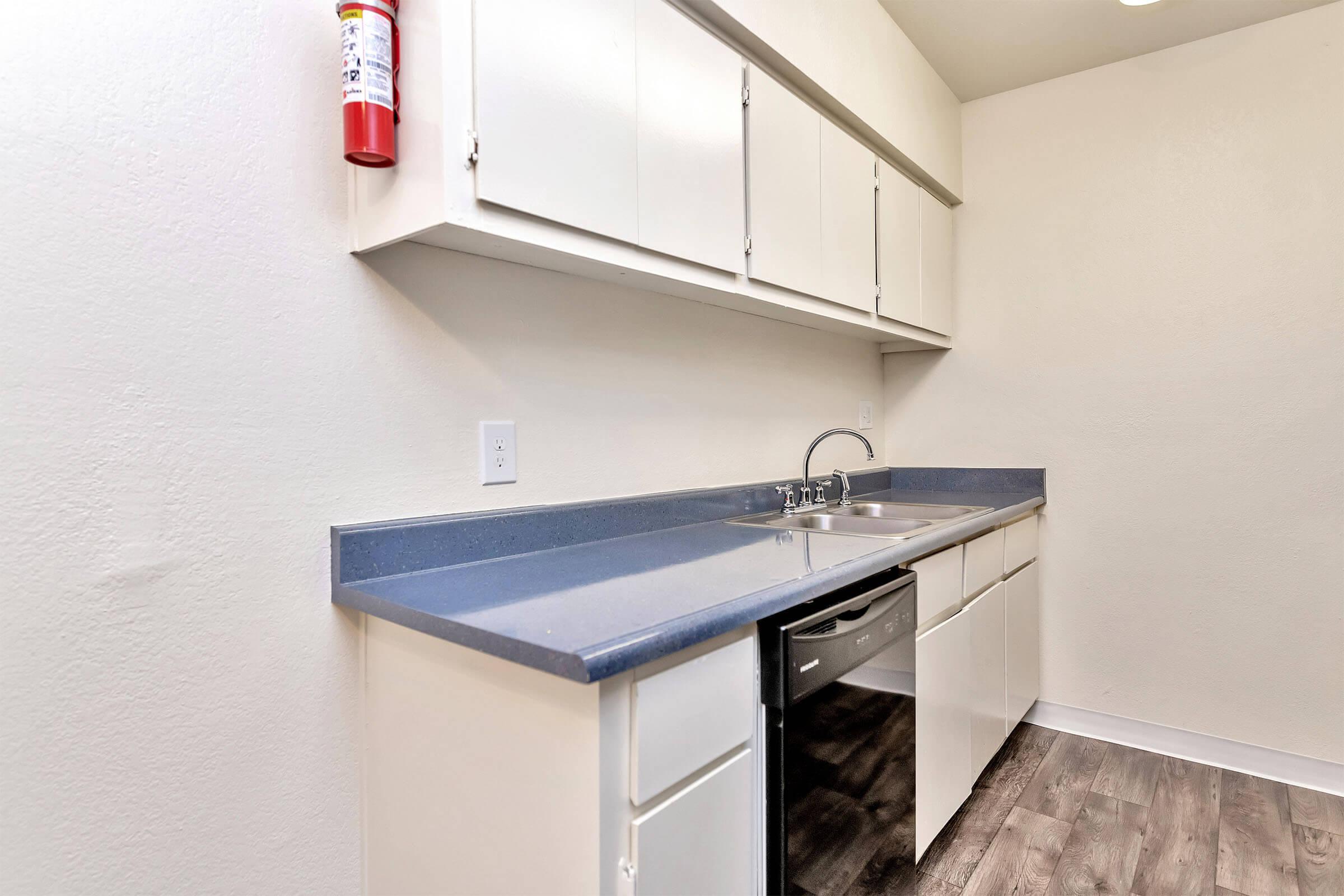 a kitchen with a sink and a refrigerator